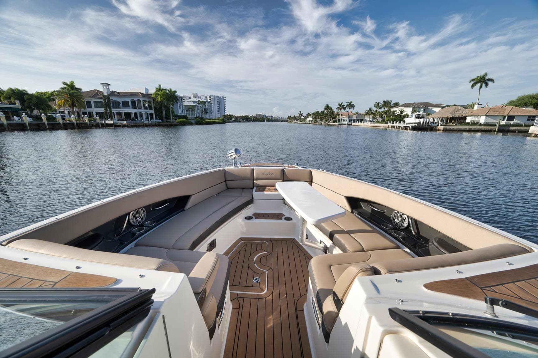 Luxurious 2016 Sea Ray 350 SLX boat with spacious seating on a scenic waterway.