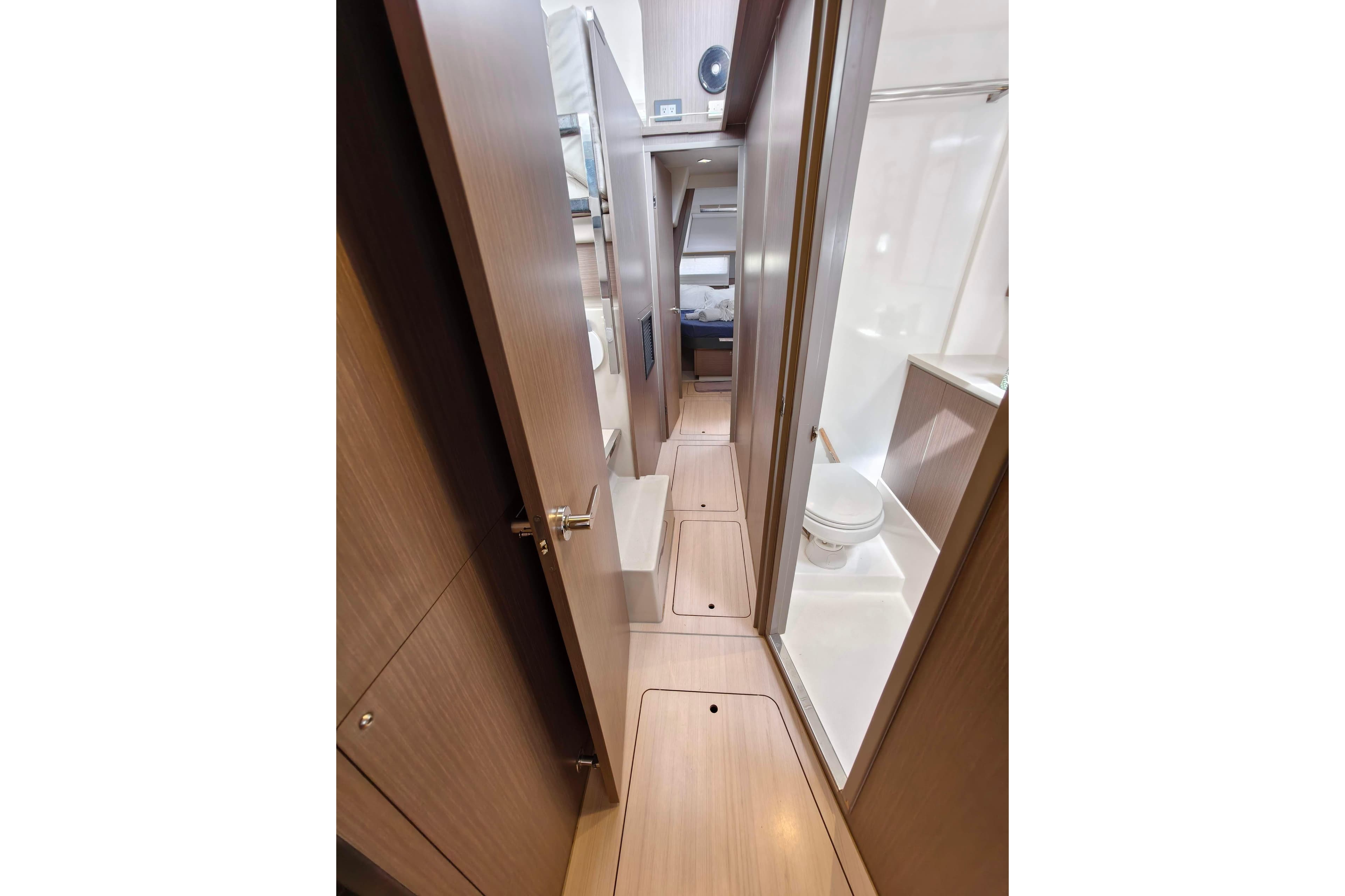Narrow hallway in 2022 Leopard 45 yacht with bathroom and bedroom access.