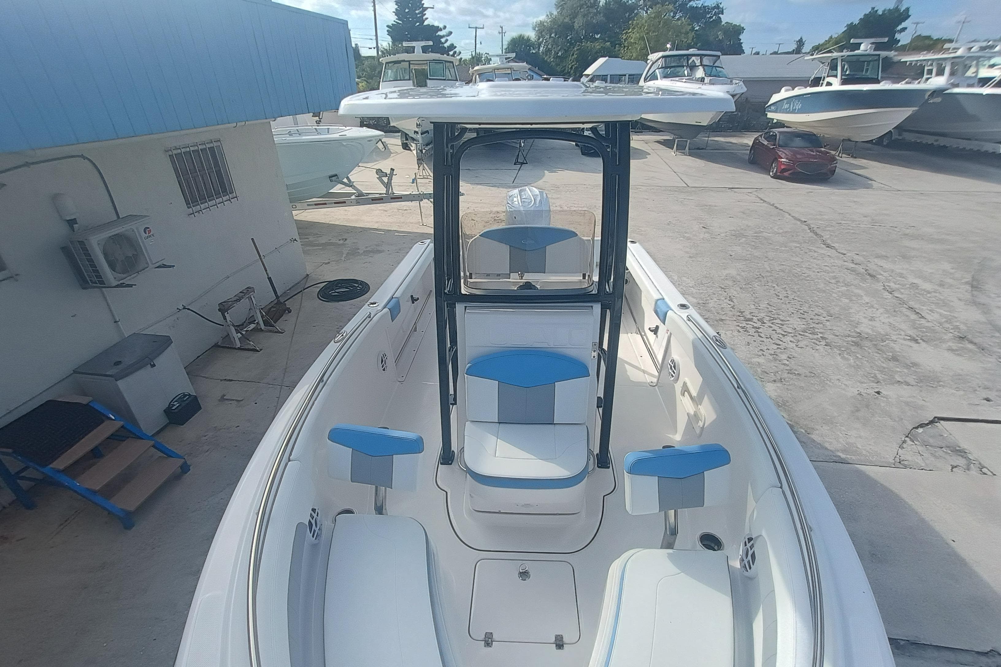 2026 Robalo R222 Center Console boat with blue and white seating, docked outdoors.
