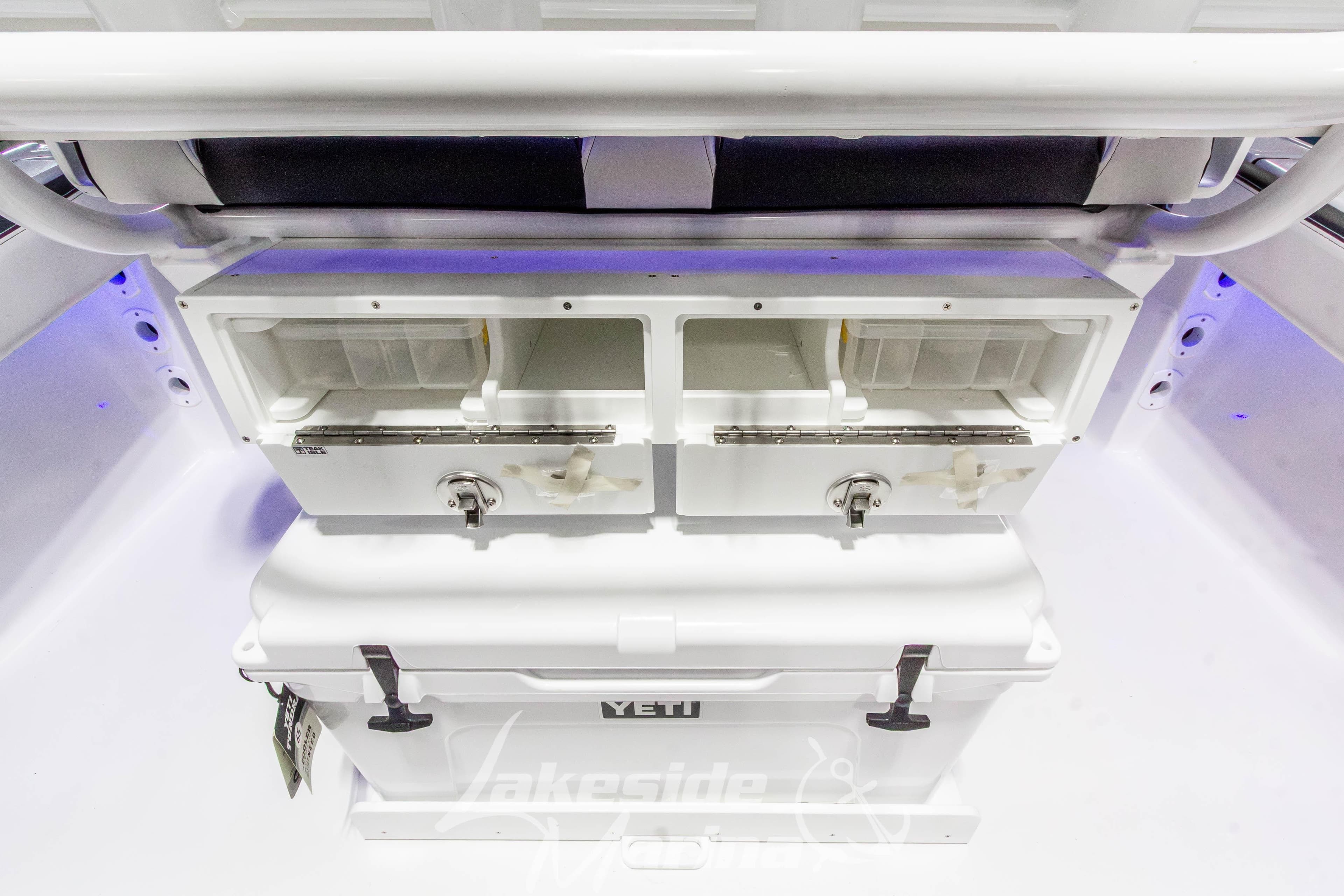 2026 Tidewater 220 LXF boat interior with storage compartments and YETI cooler.