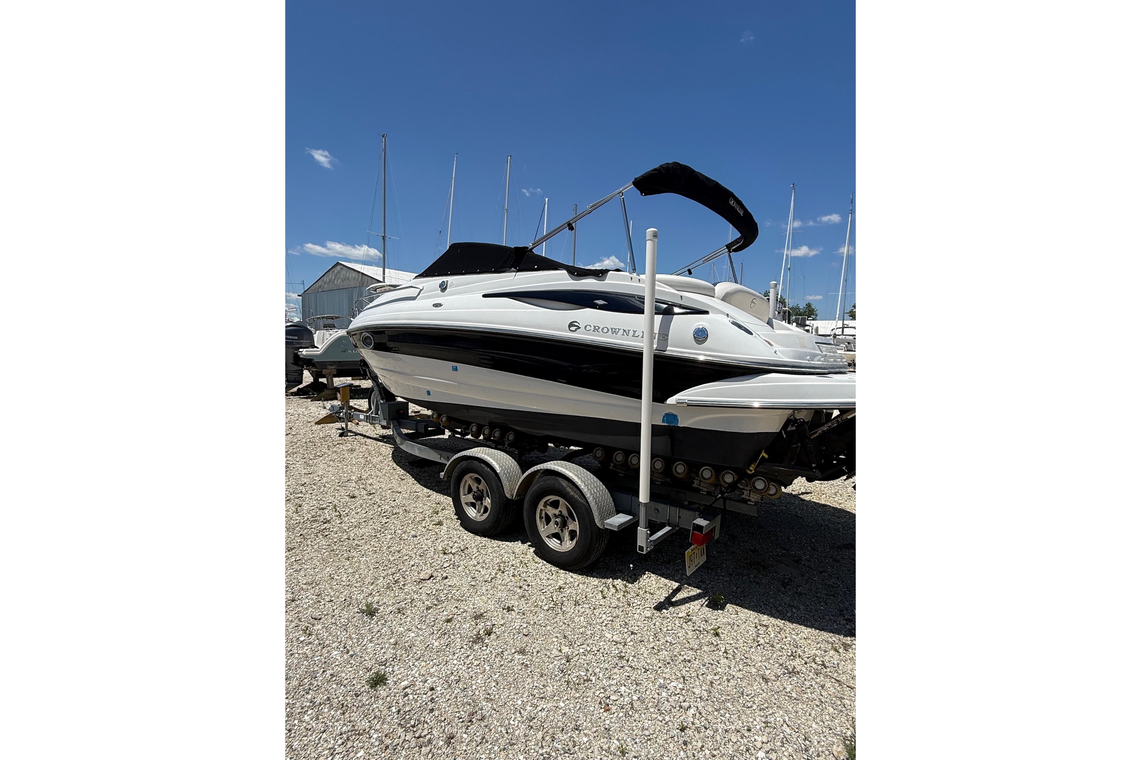 2011 Crownline 236 SC boat on trailer under clear blue sky.