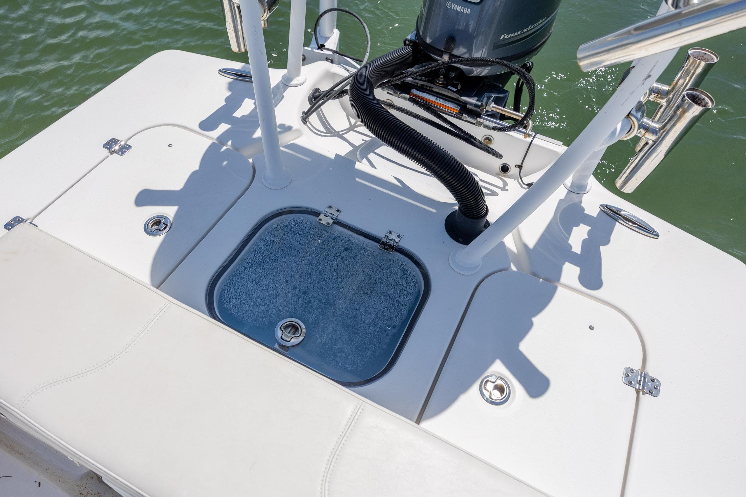 2018 Bomb Island 160 SC boat deck with motor and storage compartments.