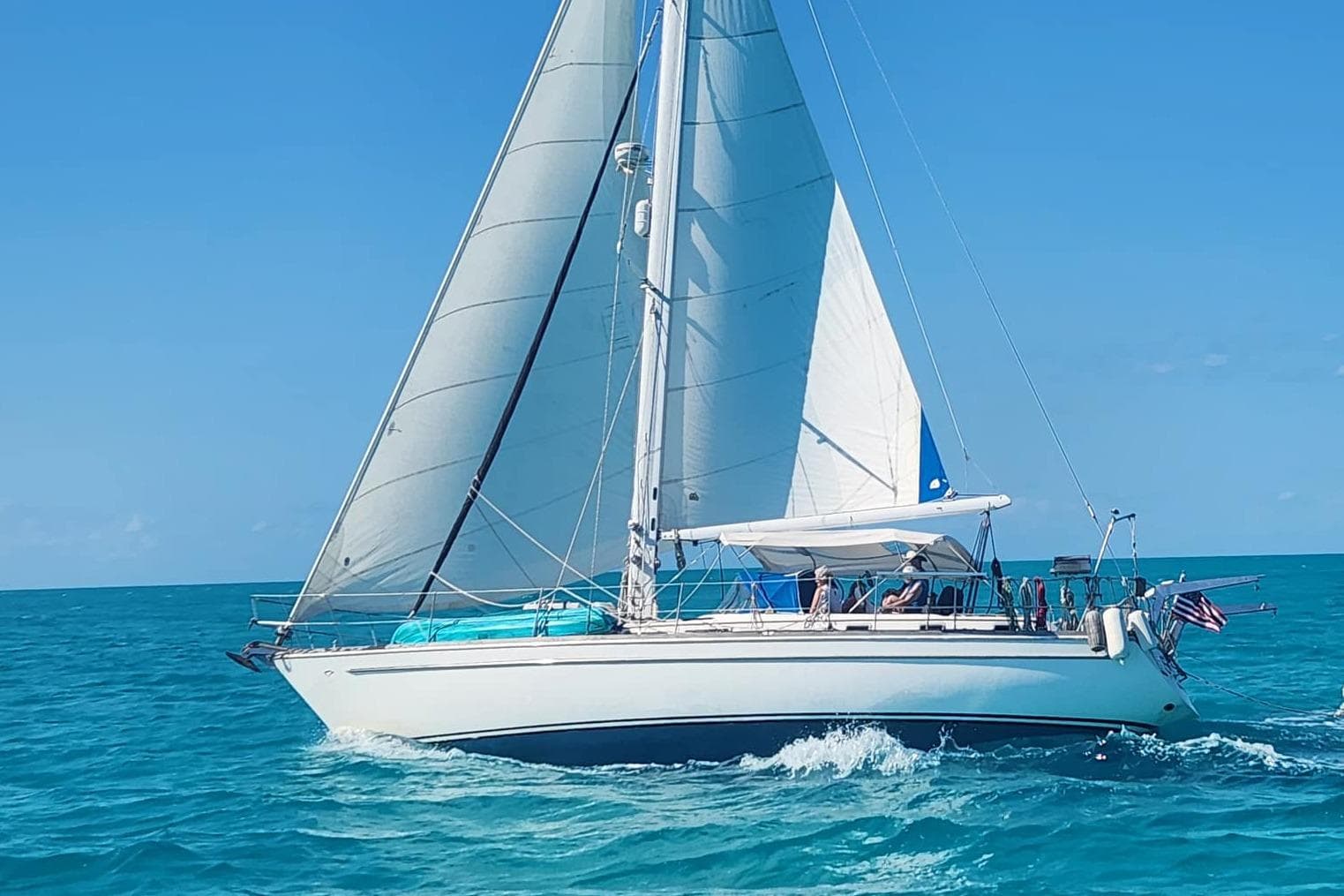 1981 Gulfstar 44 sailboat cruising on clear blue ocean waters.