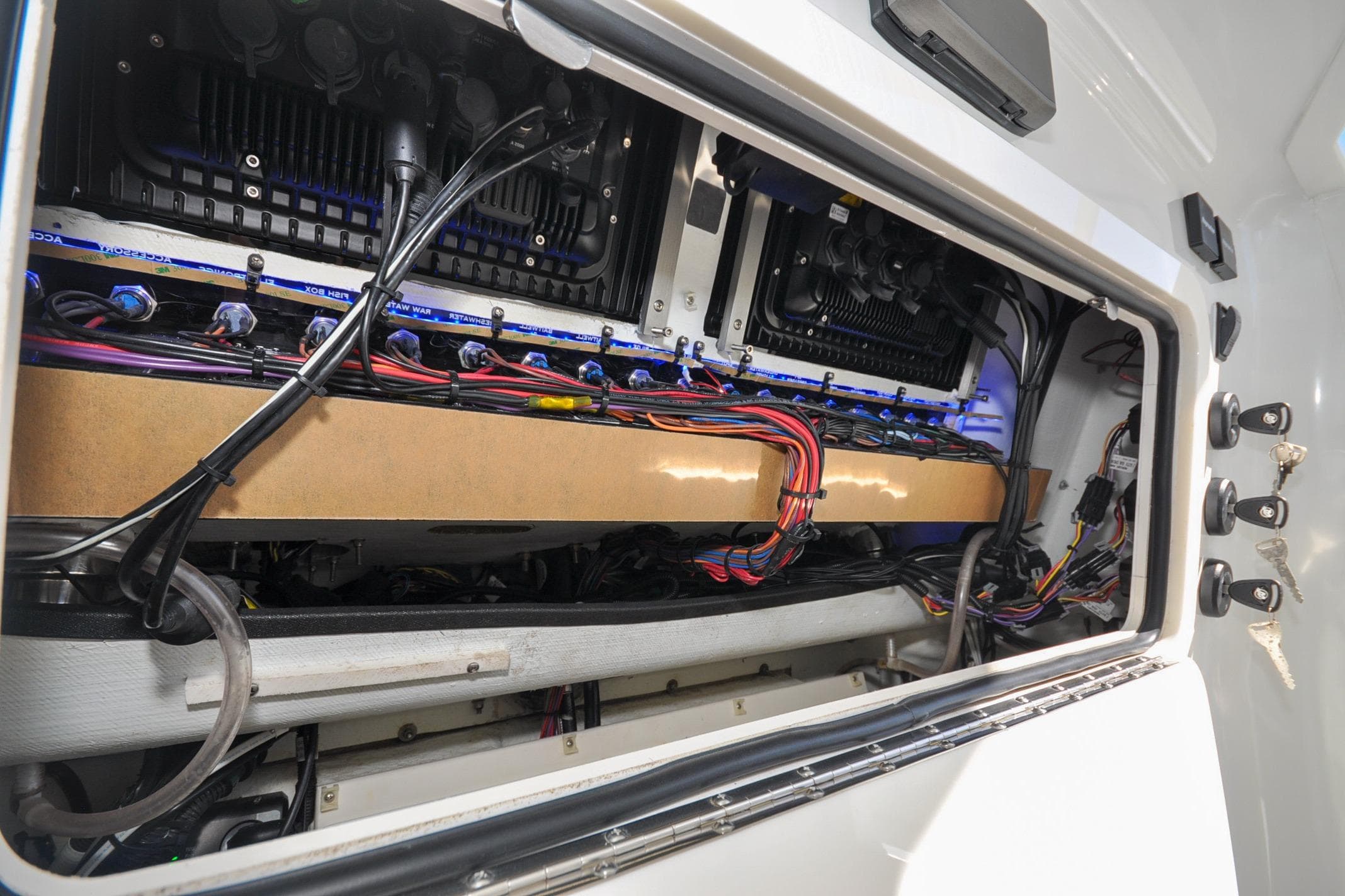 Electrical wiring inside a 2011 Yellowfin 39 Offshore boat, showcasing organized cables and components.