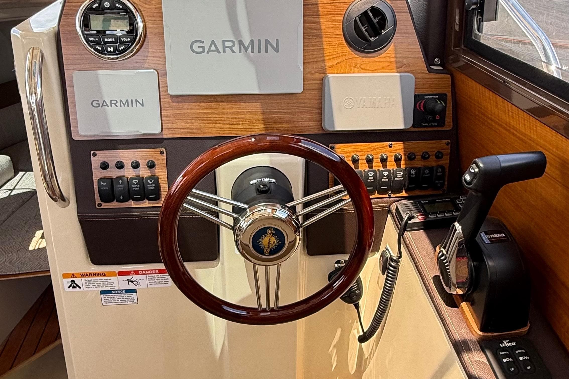 2025 Ranger Tugs R-23 helm with Garmin navigation, Yamaha controls, and wood accents.