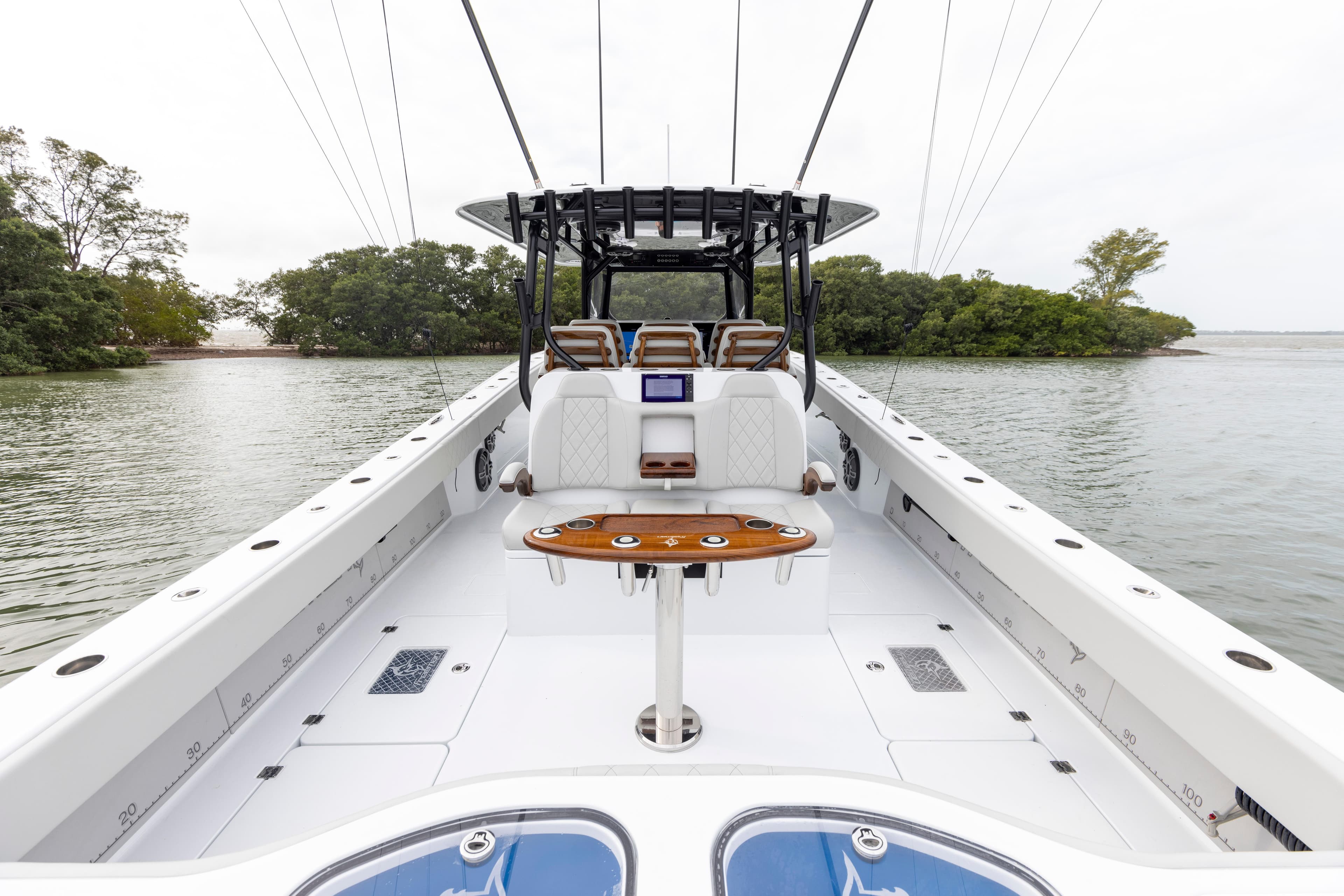 2024 Freeman 42 LR boat interior with seating and fishing rod holders.