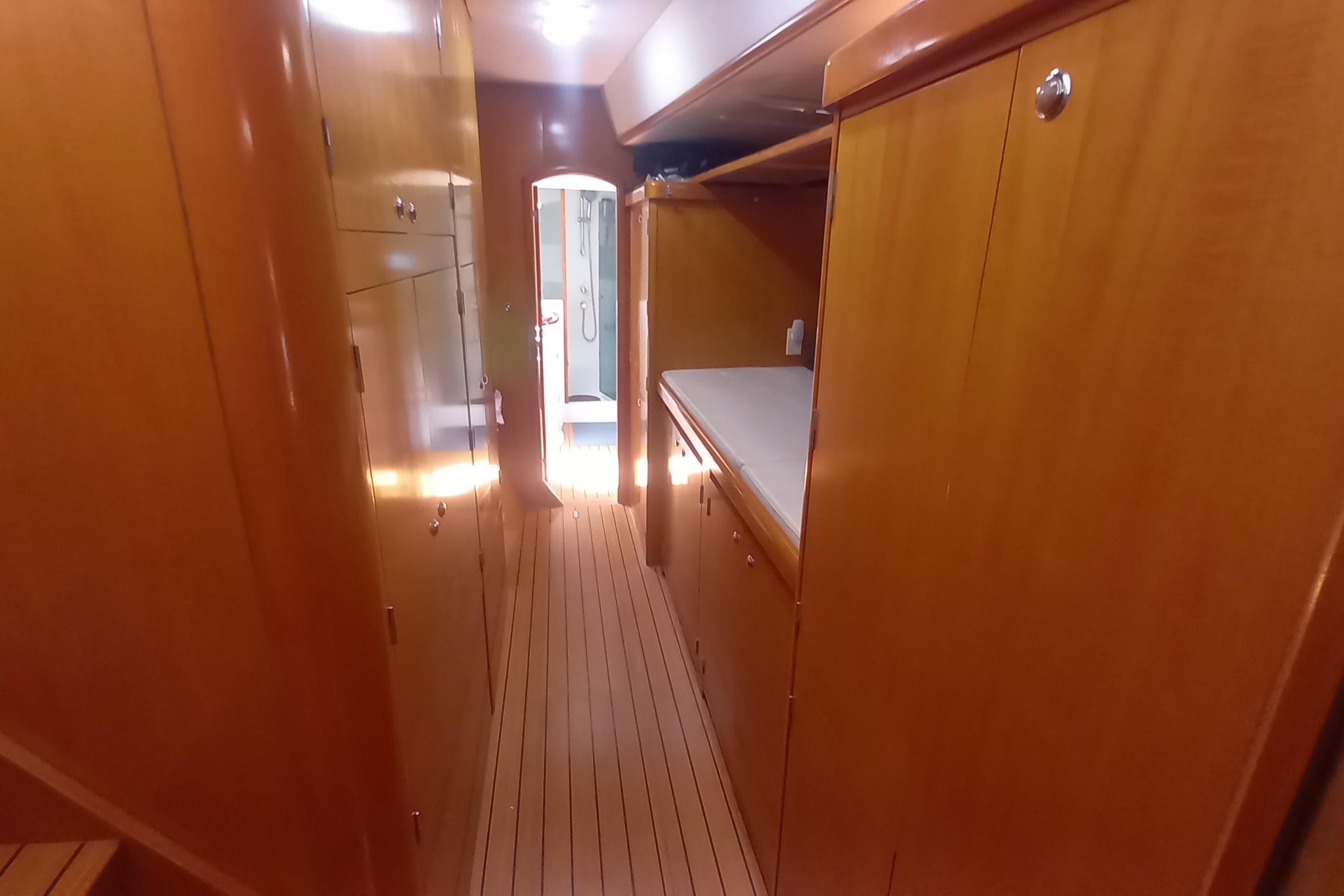 Interior hallway of 2002 Lagoon 470 yacht with wooden cabinetry and flooring.