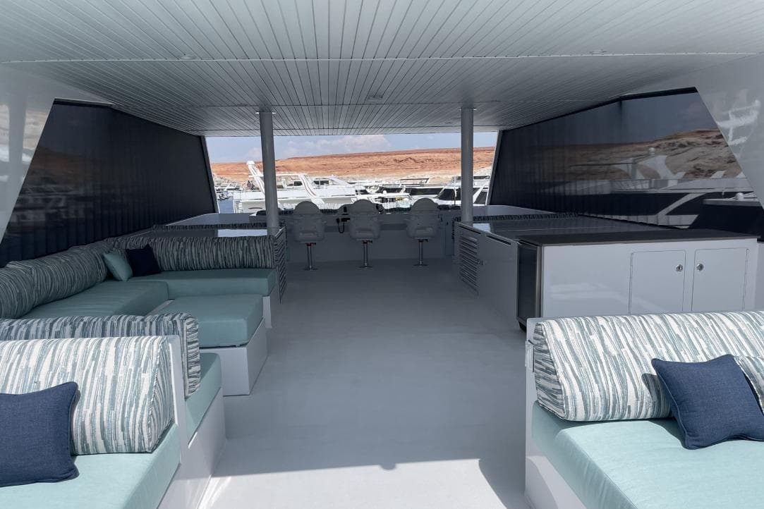 Luxurious Adonia houseboat interior with modern seating and scenic marina view, 2021 model.