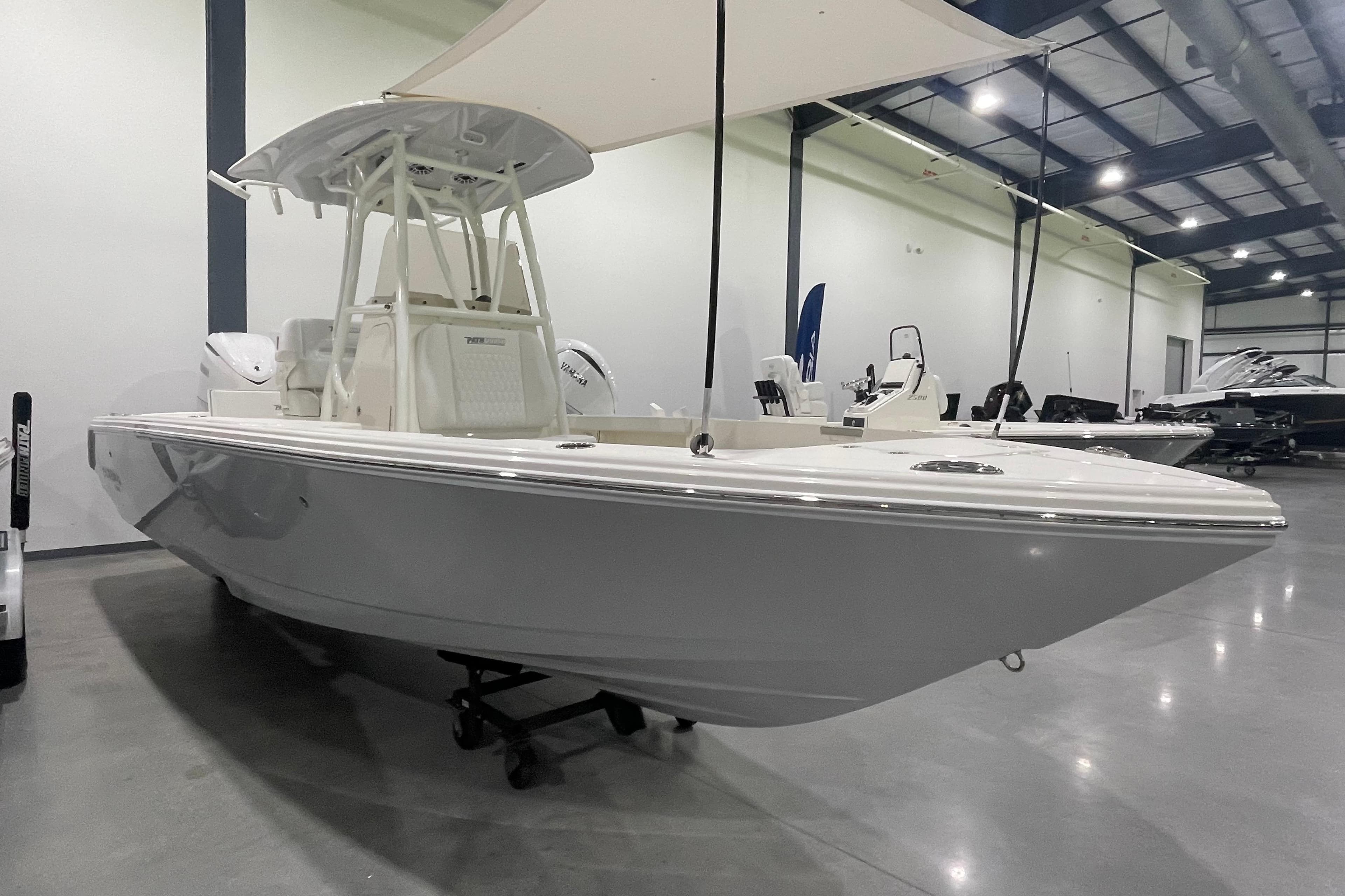2026 Pathfinder 2400 TRS boat displayed in a spacious indoor showroom.
