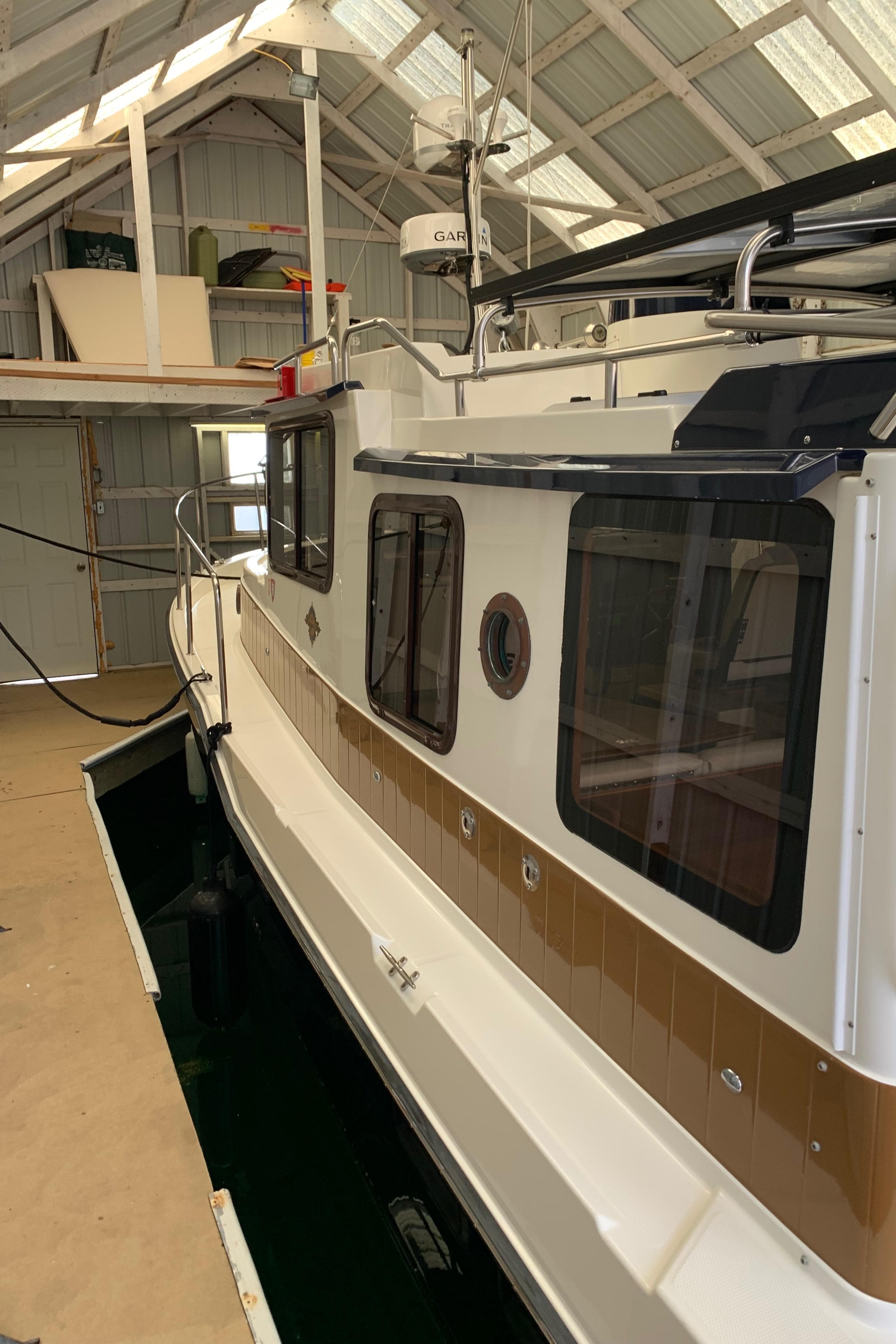 2014 Ranger Tugs Trawler docked in a covered boathouse.