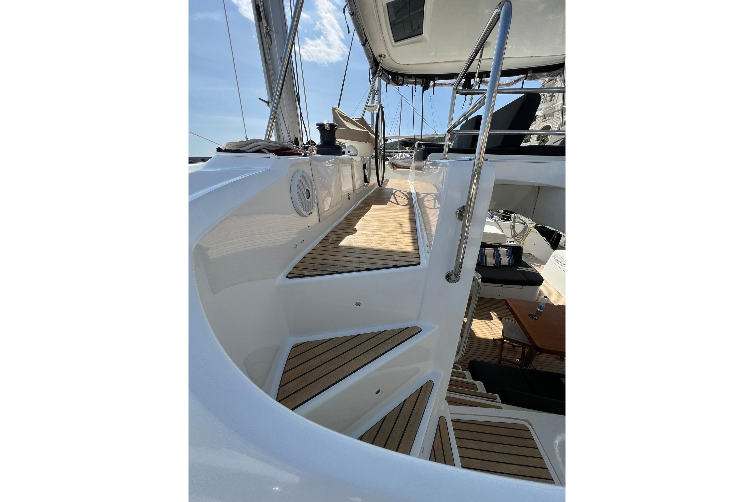 Staircase on 2020 Lagoon 50 catamaran with teak decking and stainless steel railings.