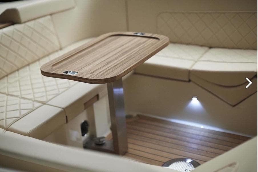 Luxurious interior of 2019 Chris-Craft Corsair 30 with elegant seating and wooden table.