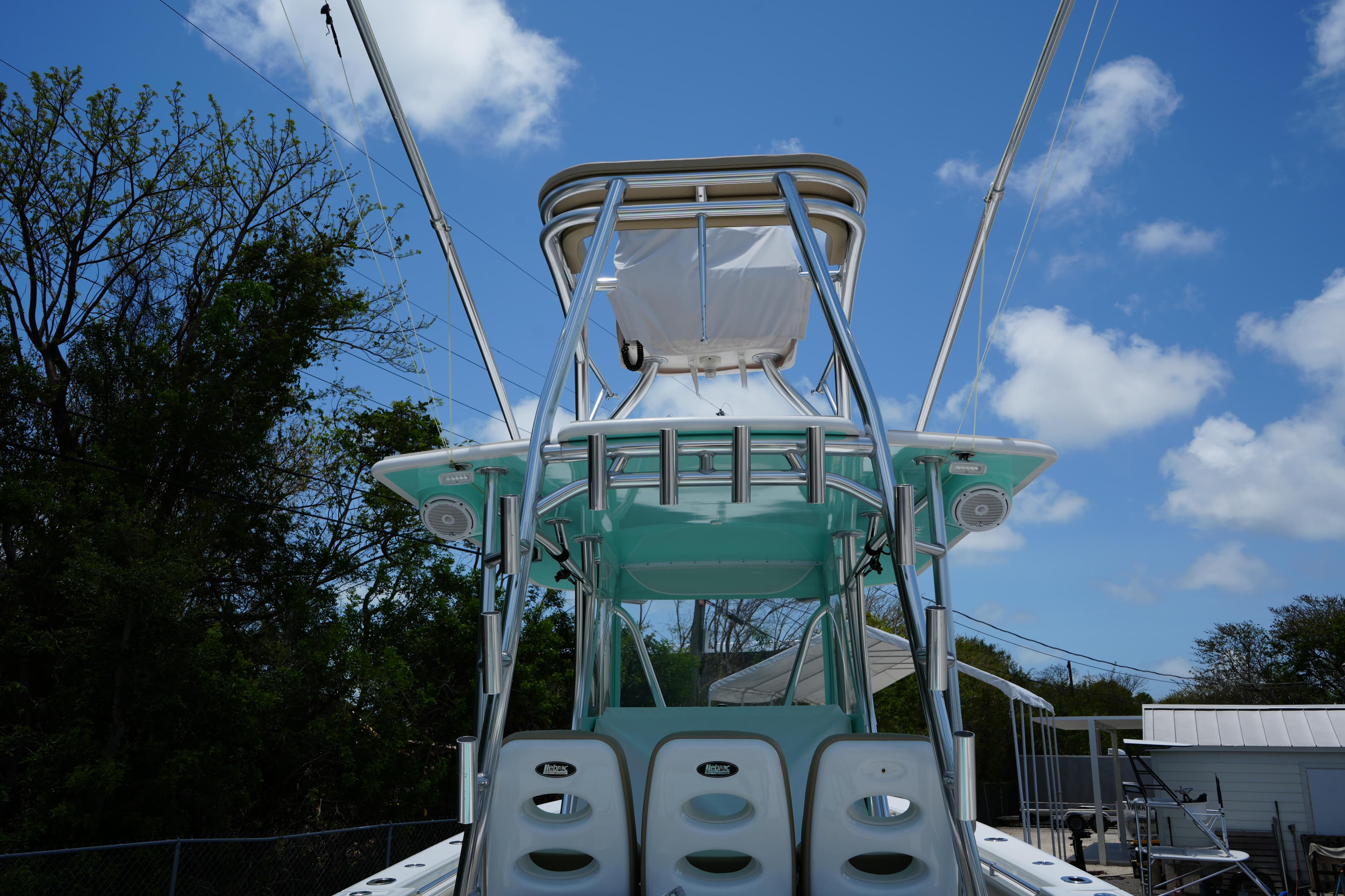 2015 Contender 39ST boat with tower against a clear blue sky.
