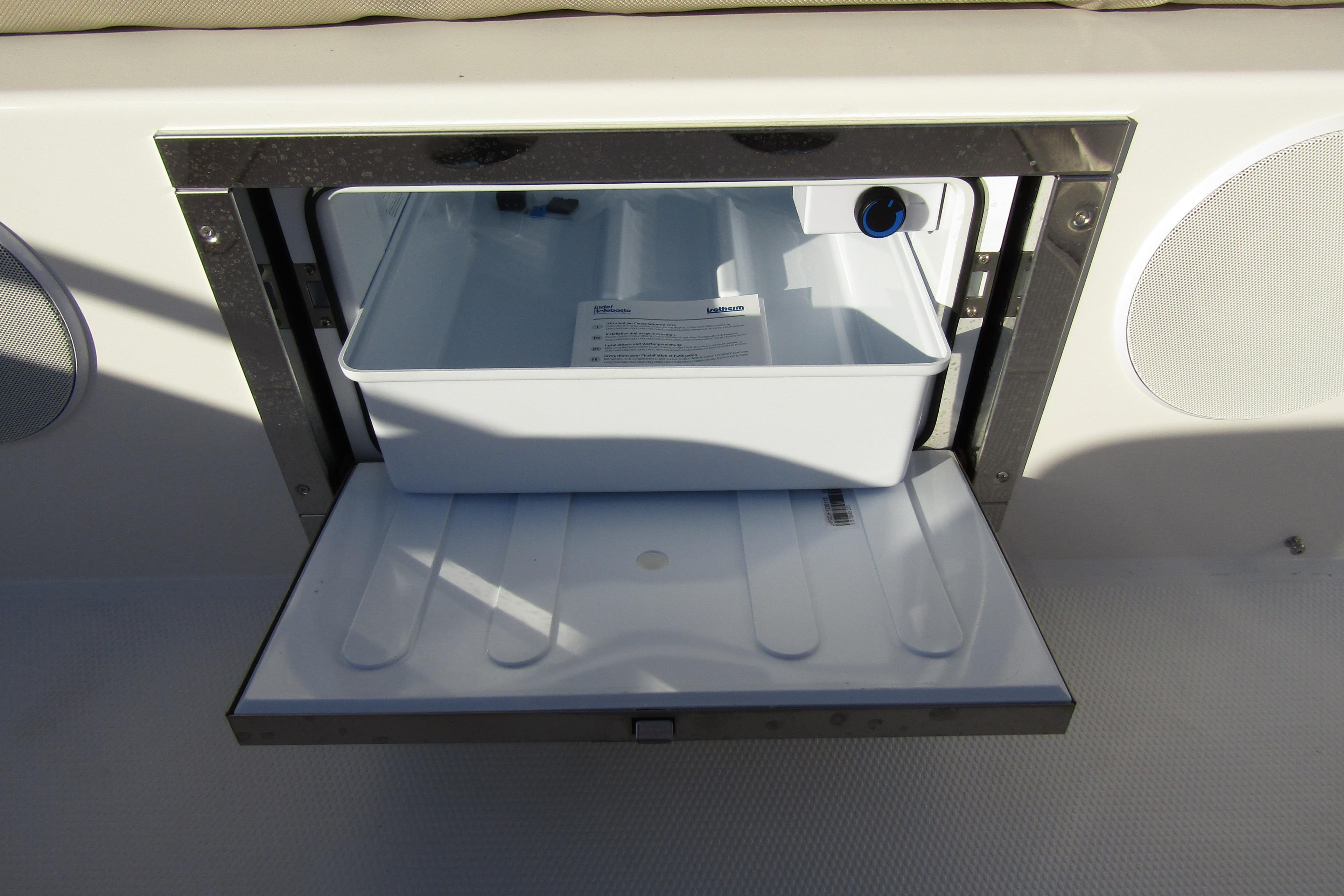 Open storage compartment on 2025 Nimbus Tender 9 boat, featuring a white interior tray.