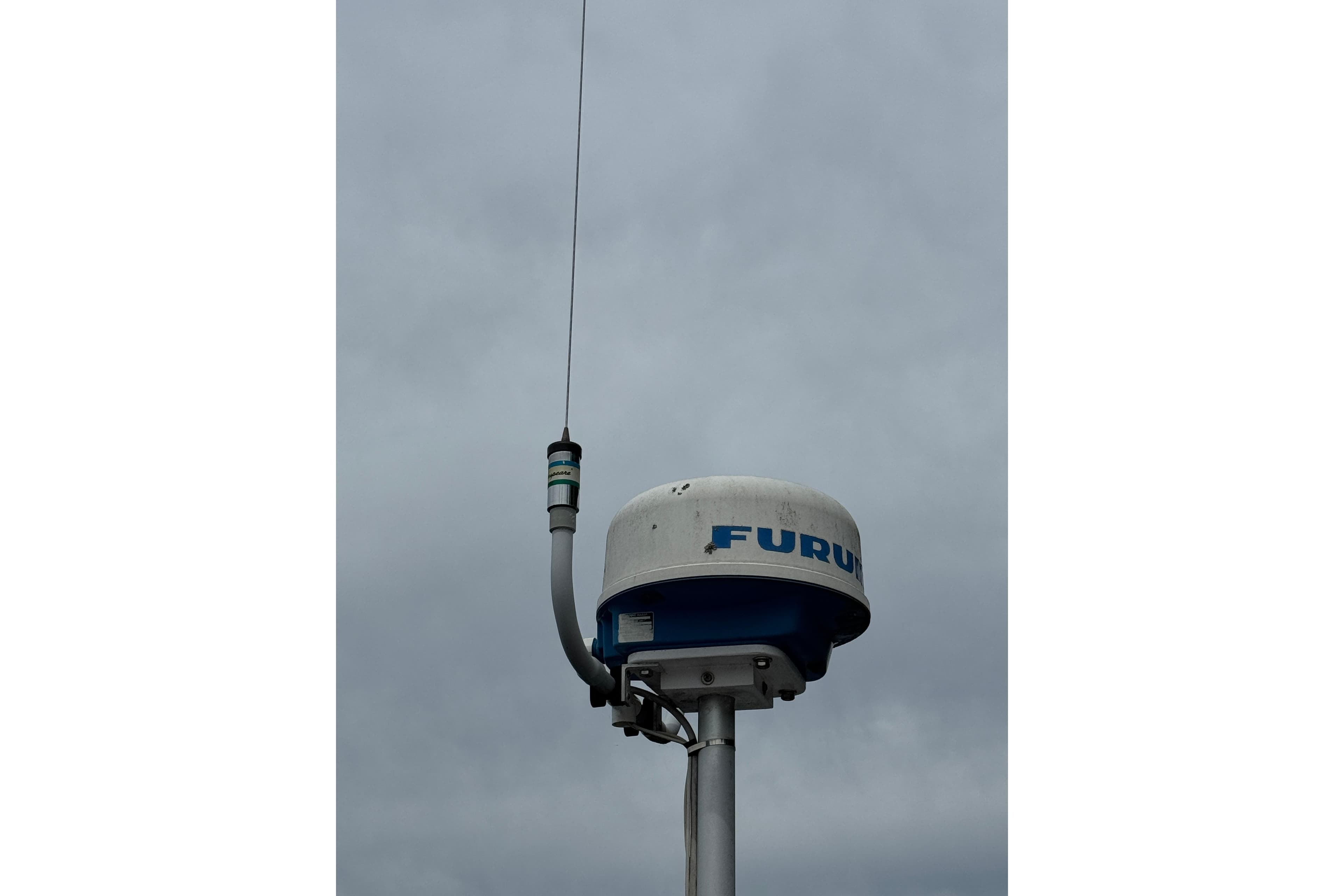 Marine radar antenna against cloudy sky, featuring Furuno branding, 1972 Ranger model.