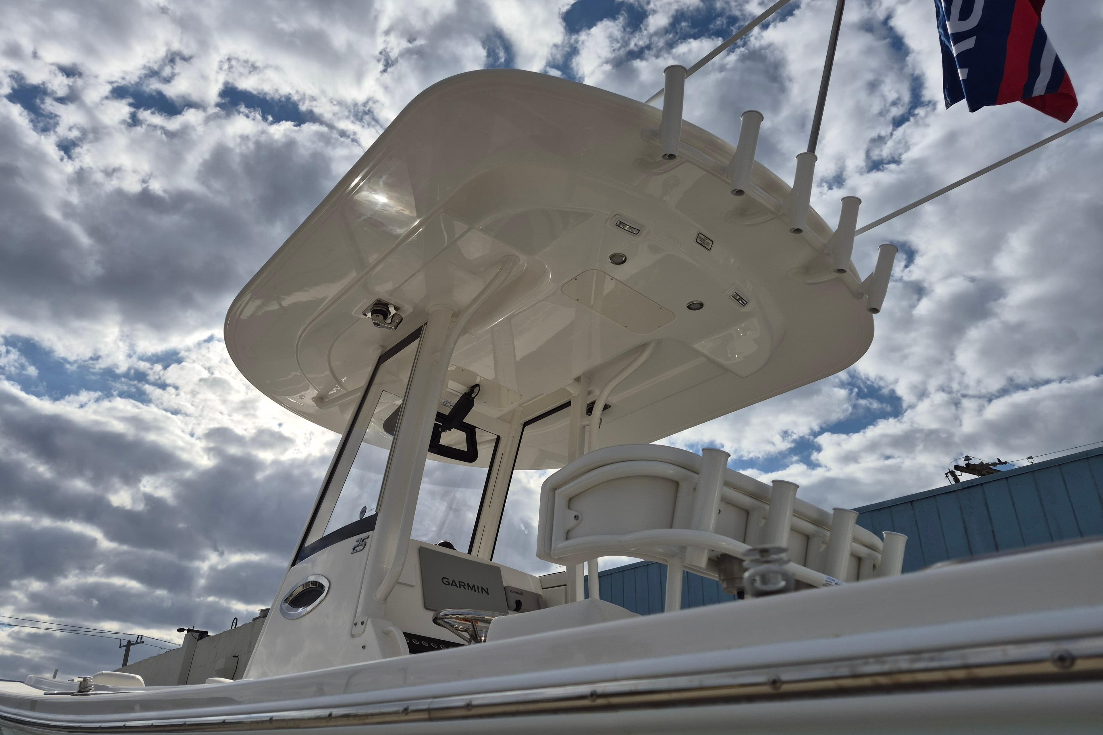 2026 Regulator 25 boat with T-top against a cloudy sky background.