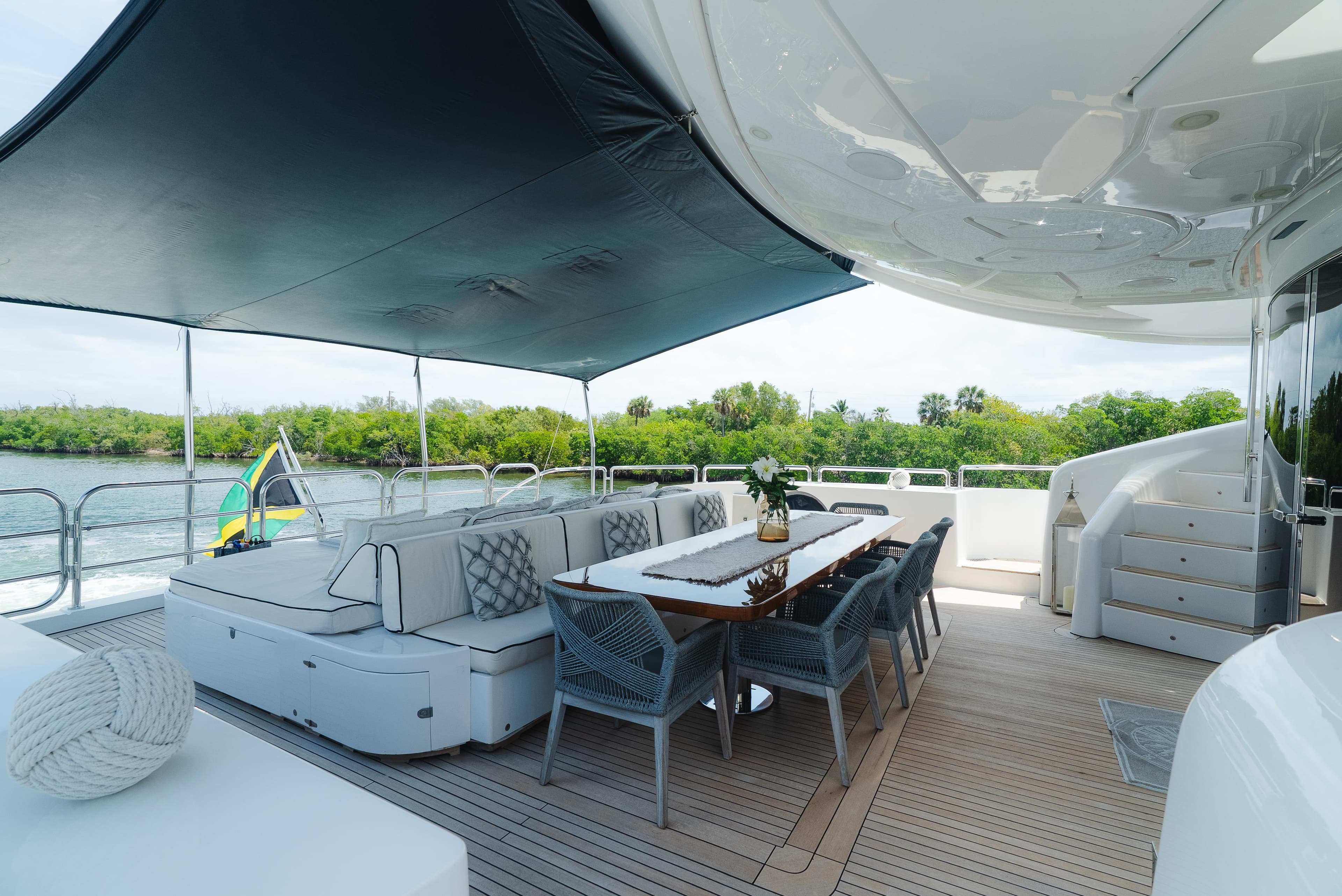 Luxurious Arno Leopard 46 yacht deck with elegant seating, dining area, and scenic water view.