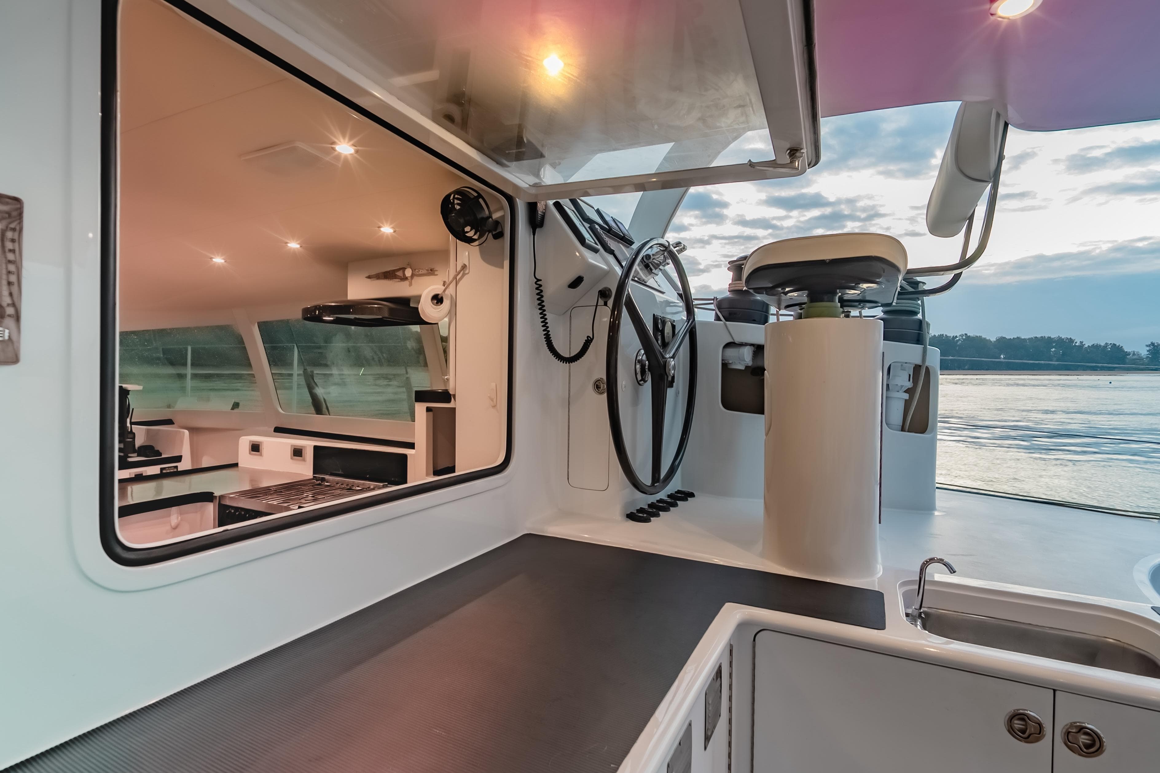 Luxurious 2012 Morrelli & Melvin 65 custom yacht interior with modern helm and kitchen.