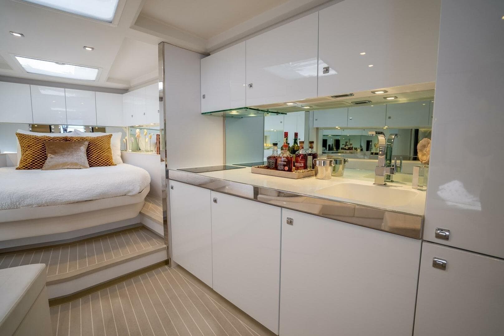 Luxurious interior of 2016 VanDutch 55 yacht with modern kitchen and cozy bedroom.