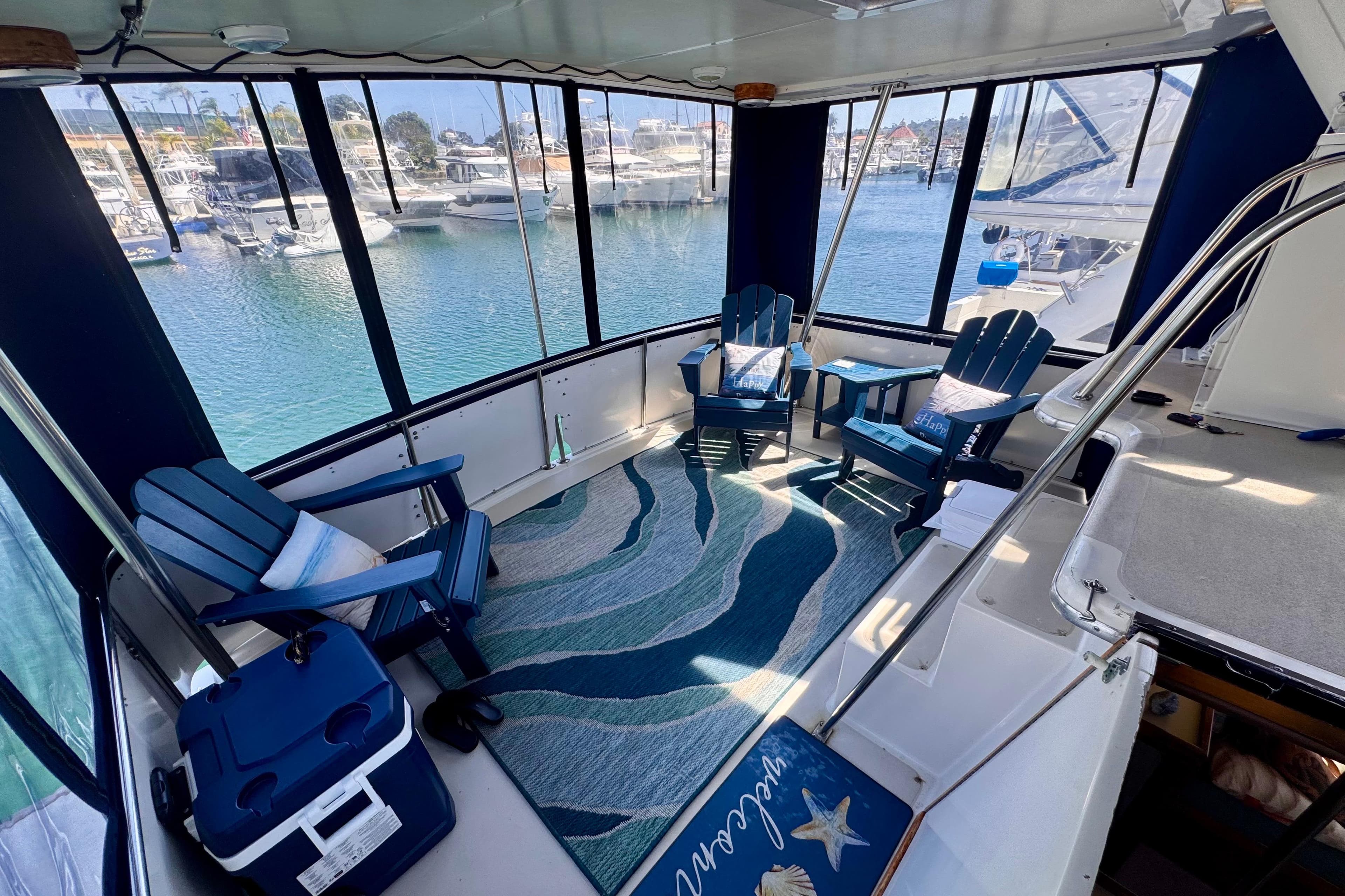 Californian 35 Motor Yacht 1985 interior with blue chairs and marina view.