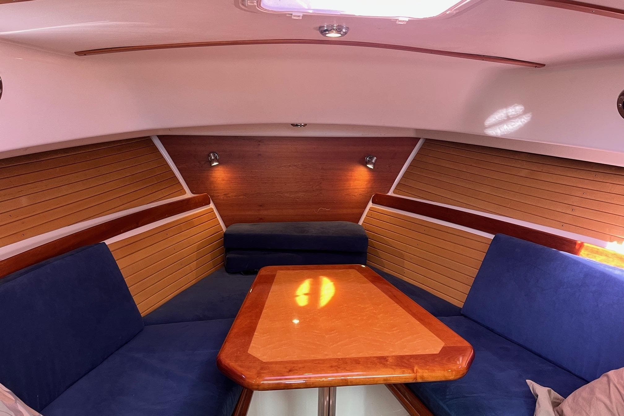 2008 Back Cove 29 interior with blue seating and wooden accents.