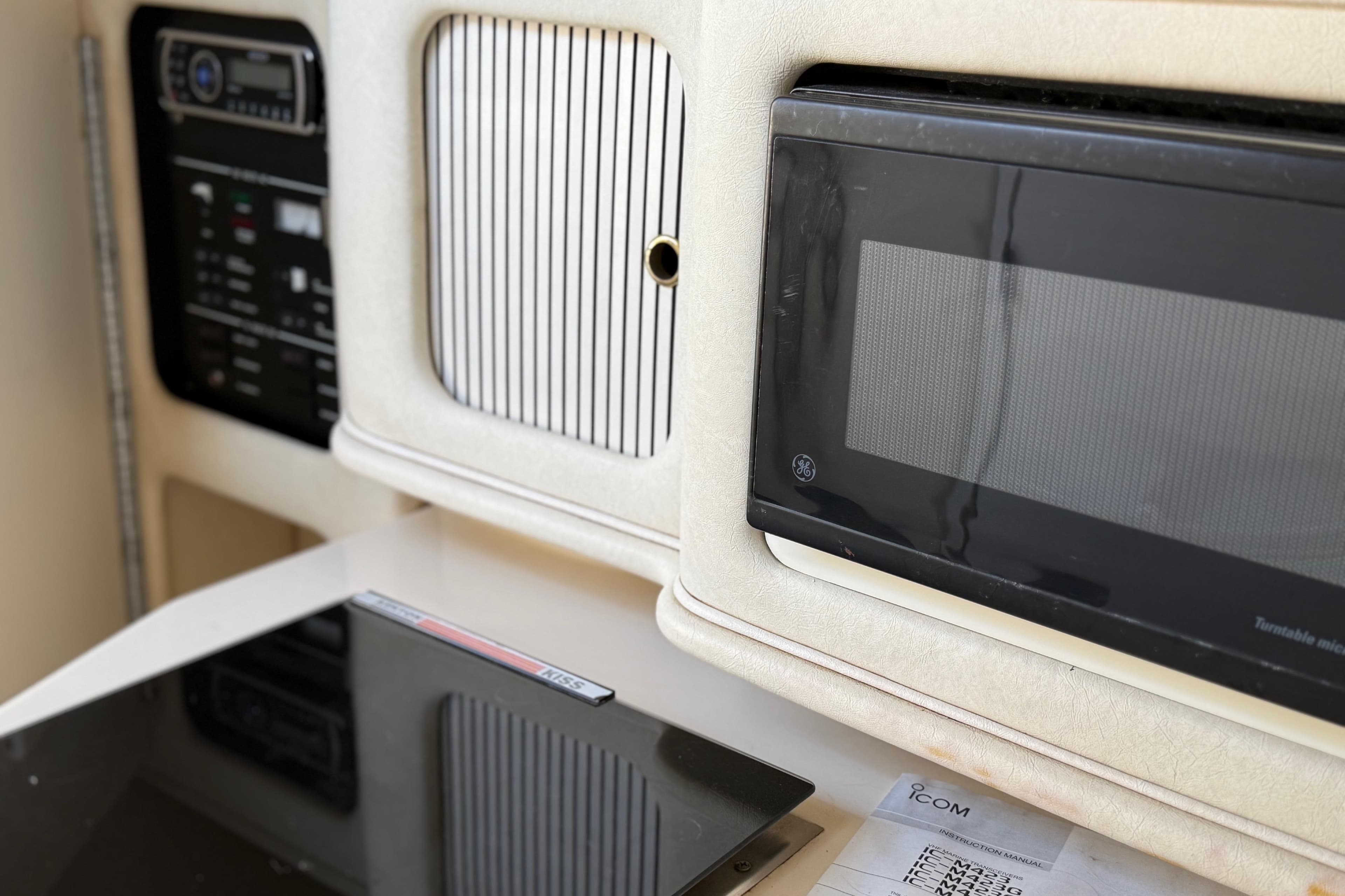 Interior of 2001 Sea Ray 260 Sundancer with microwave and control panel.