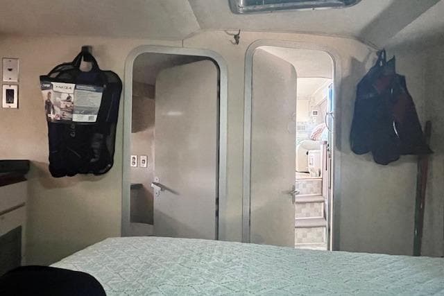 Interior of 1989 Trojan 12 Meter Motor Yacht cabin with bed and open doors.