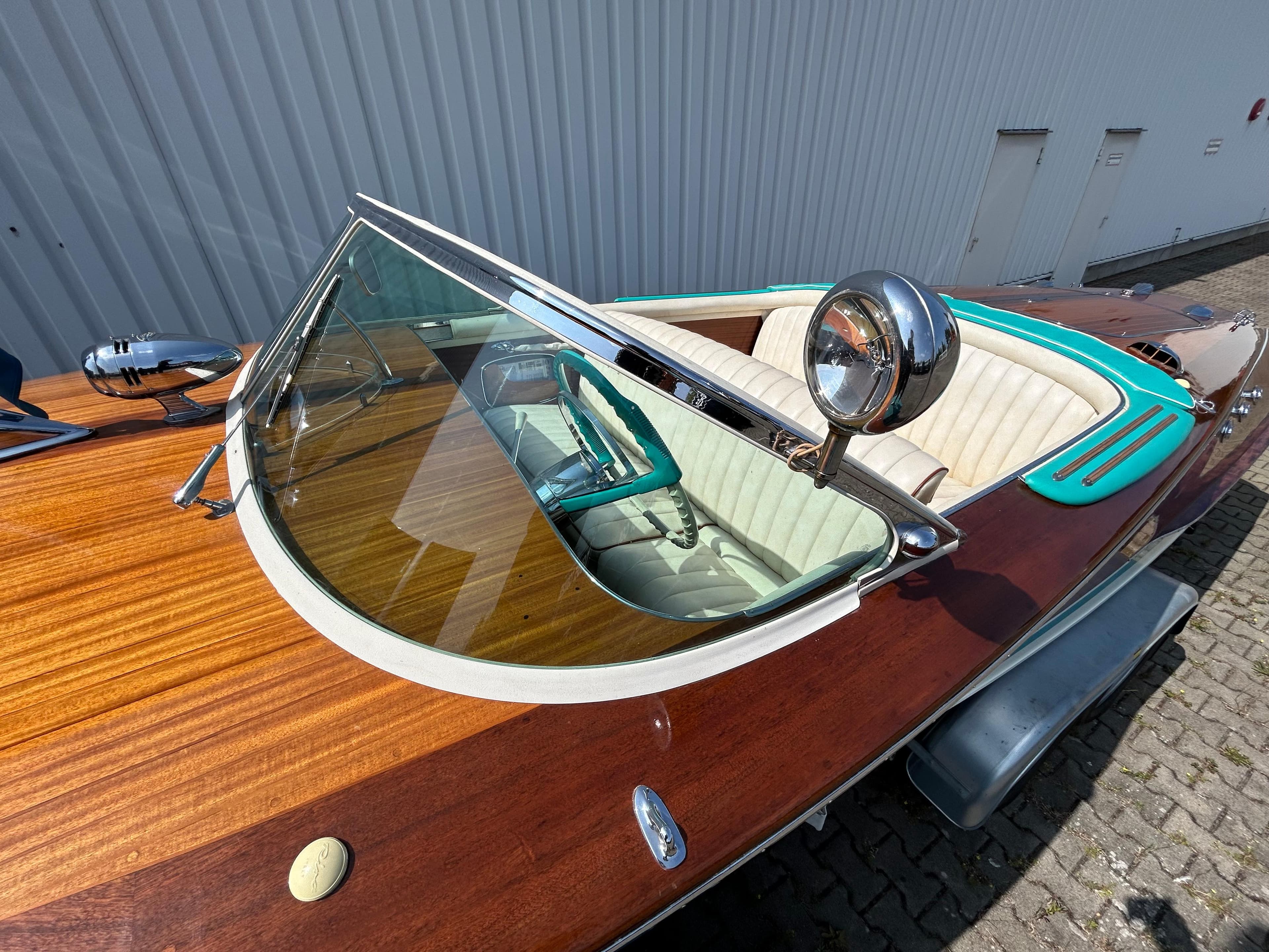 1963 Riva Ariston boat with wooden deck, chrome details, and classic windshield.