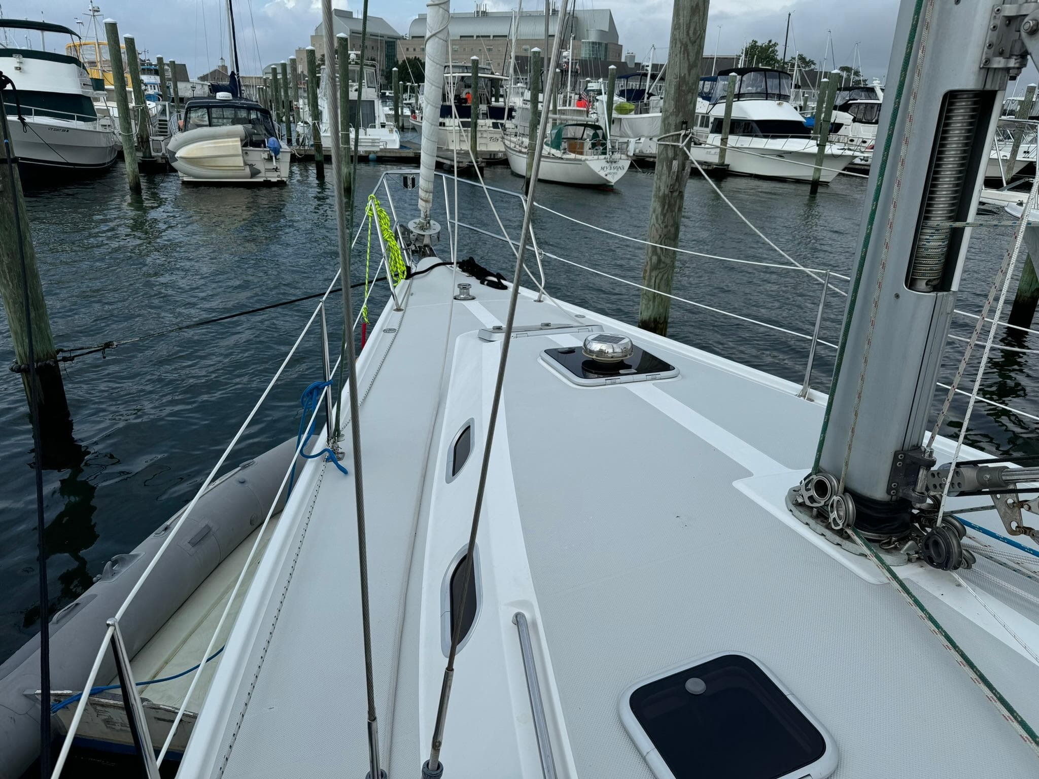 2004 Catalina 42 MkII sailboat docked in marina, surrounded by other boats.