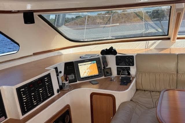 Luxurious 2007 Africat Marine 420 yacht interior with navigation equipment and leather seating.