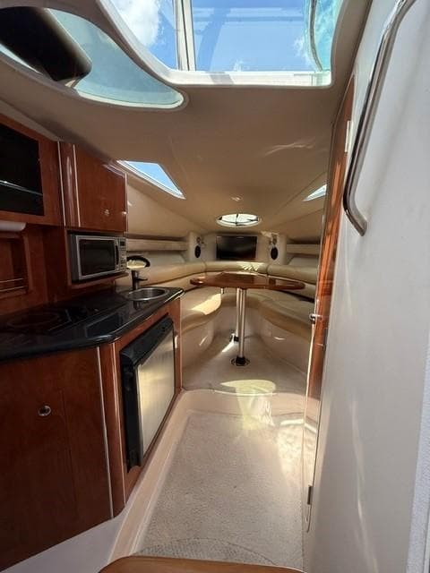 Interior of 2009 Doral Monticello boat with kitchenette and seating area.
