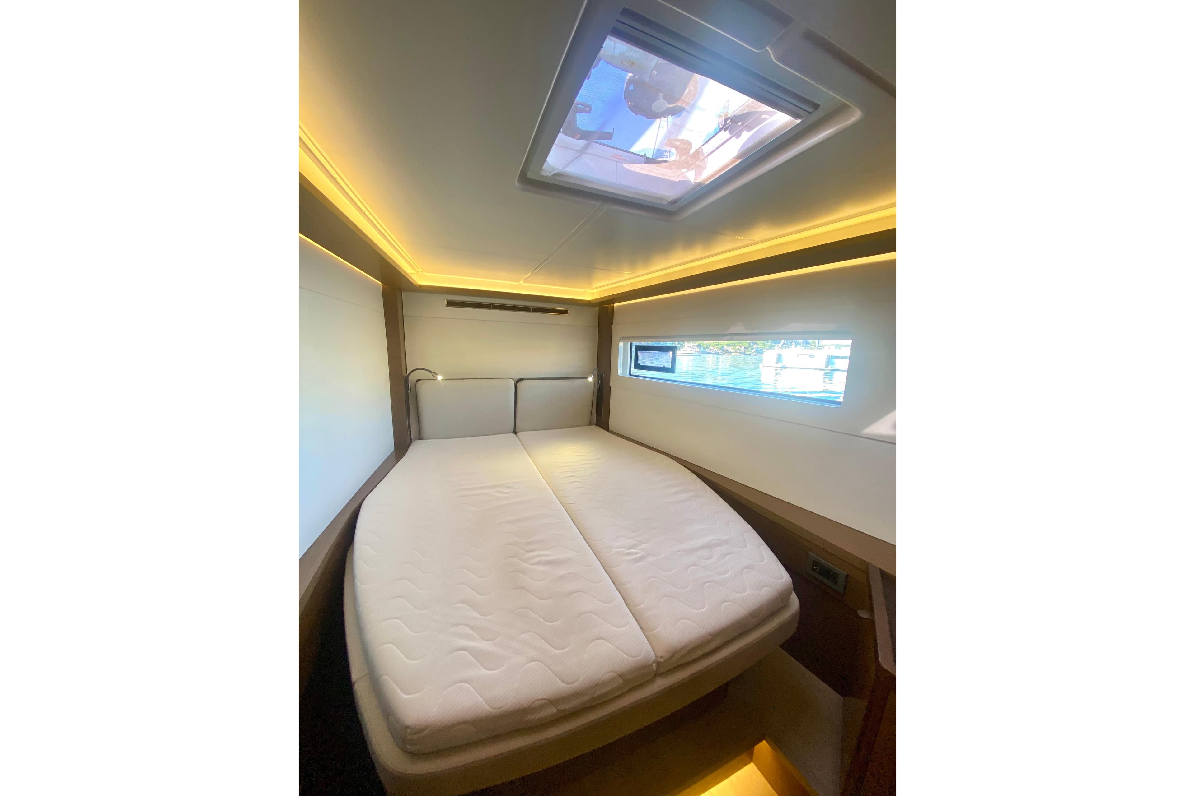 Luxurious cabin interior of 2020 Lagoon 46 yacht with skylight and ambient lighting.