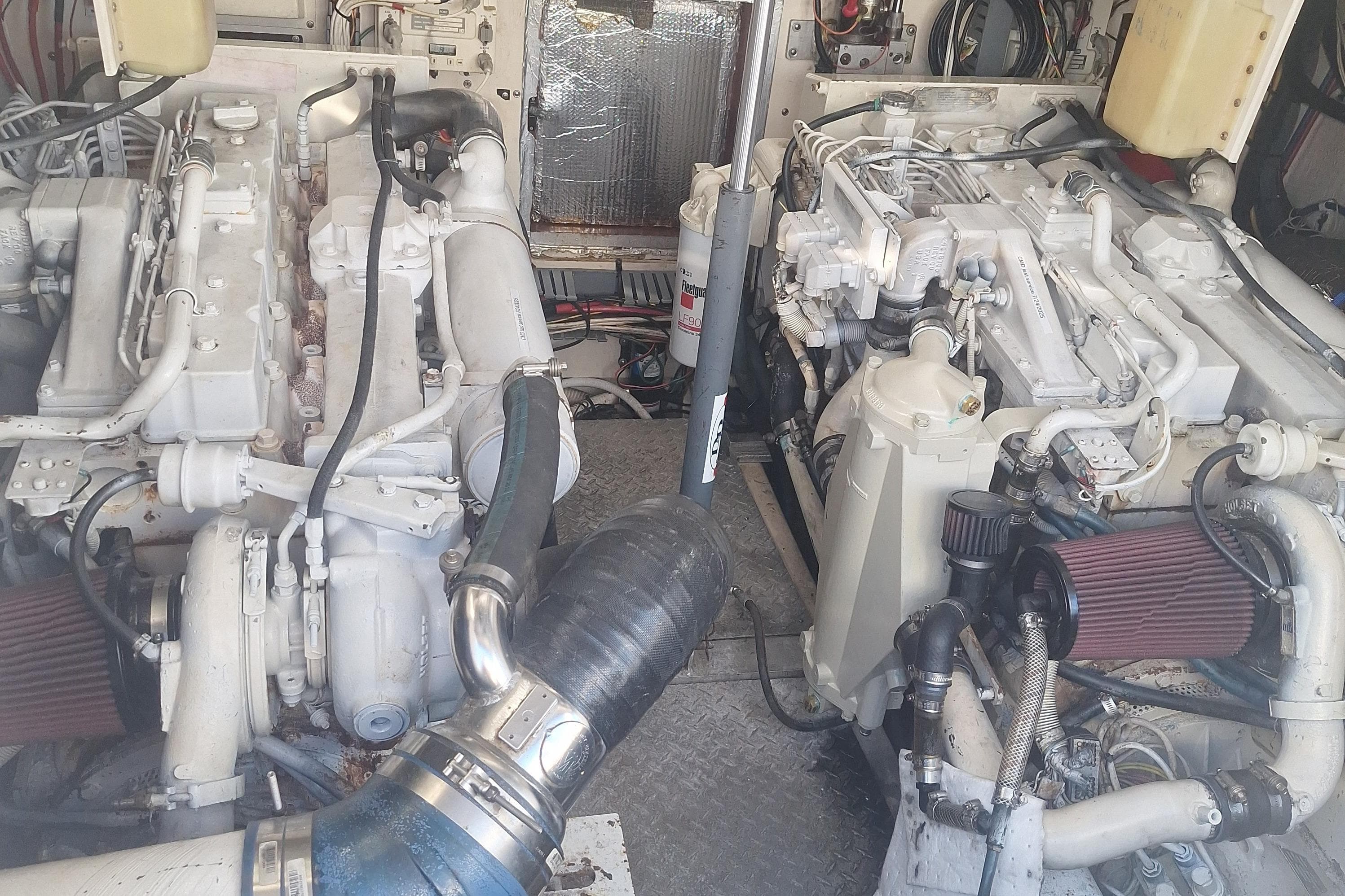 Engine room of a 2004 Luhrs 38 Open boat, showcasing dual engines and mechanical components.