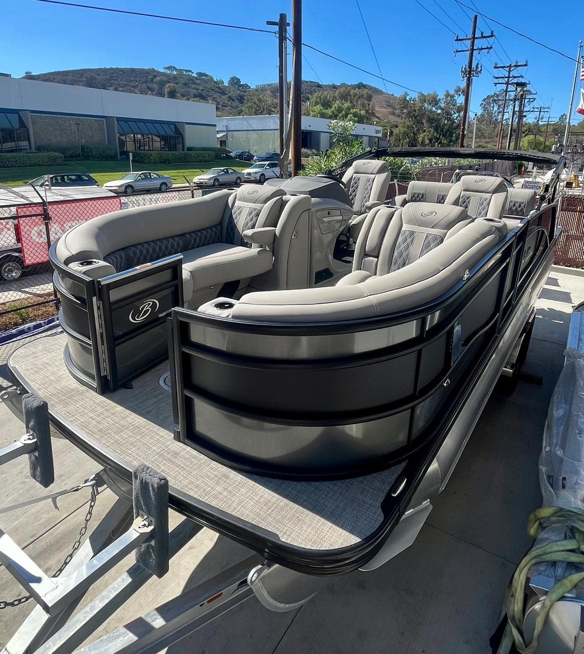 2025 Barletta Lusso 23UC pontoon boat with luxurious seating and sleek design on a trailer.