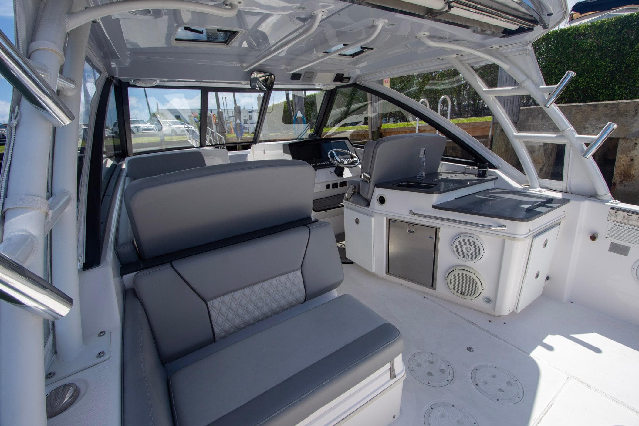 2019 Everglades 340 Dual Console boat interior with seating, helm, and kitchenette.