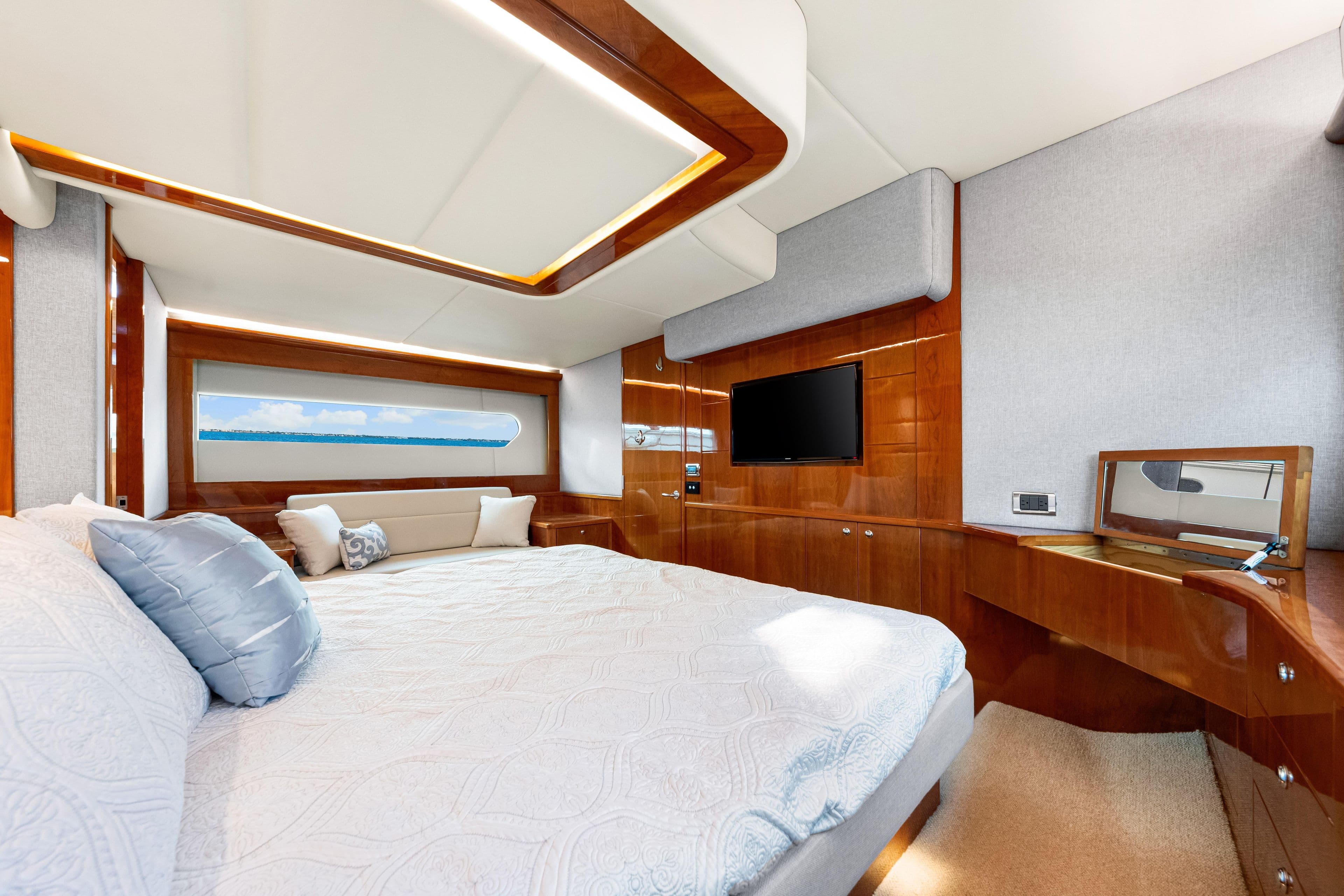 Luxurious interior of 2015 Riviera 565 SUV yacht with elegant wood finishes and modern amenities.