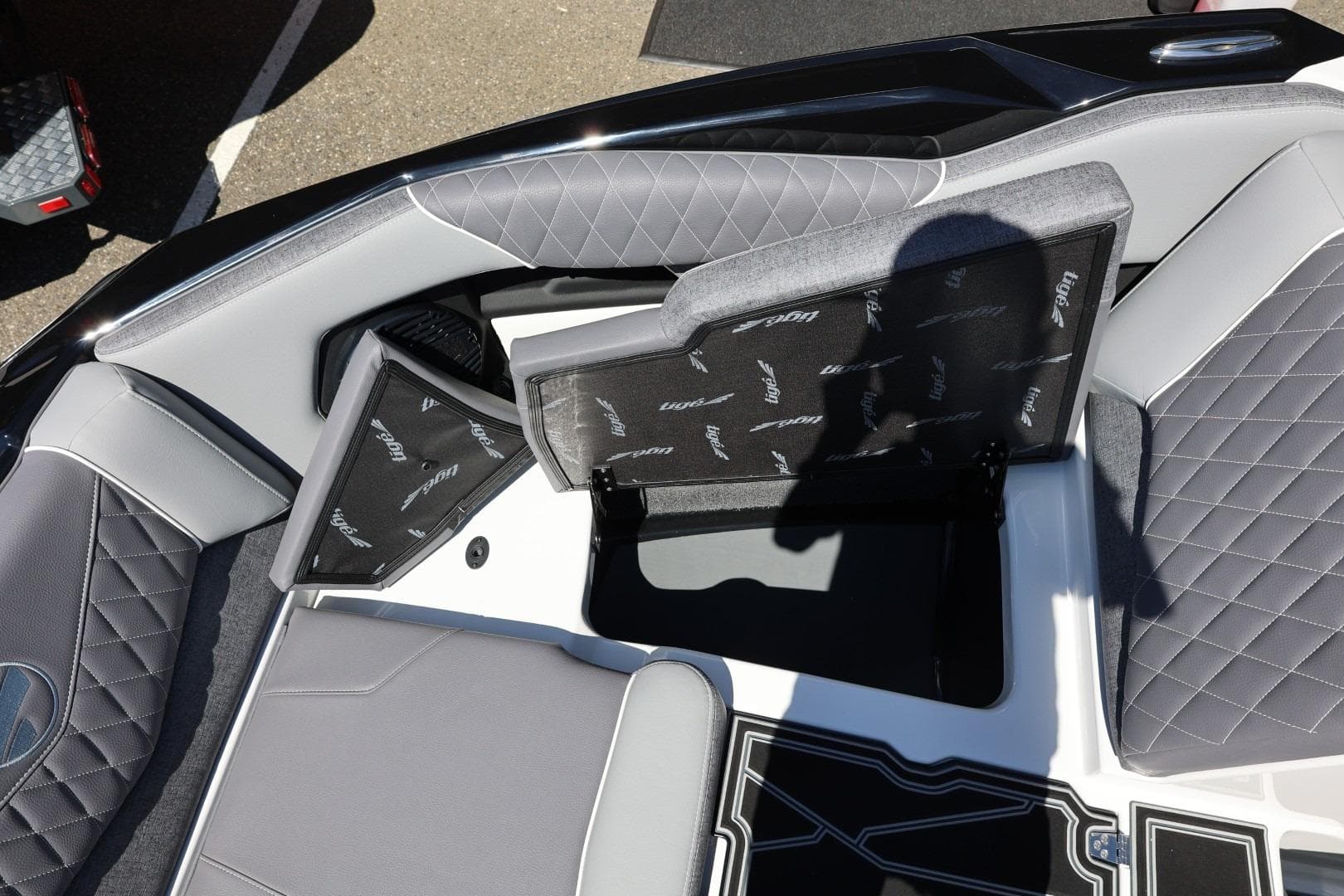 2026 Tigé Z3 boat interior with open storage compartments and quilted gray seating.
