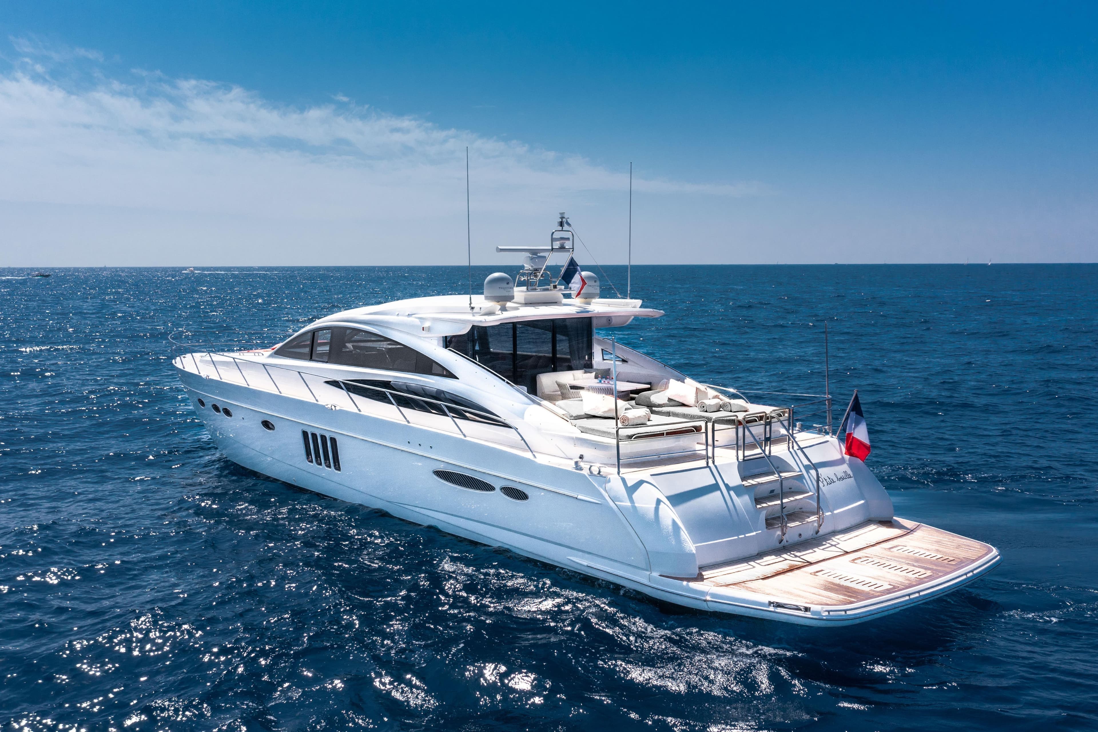 Luxurious 2008 Princess V70 yacht cruising on open sea under clear blue sky.