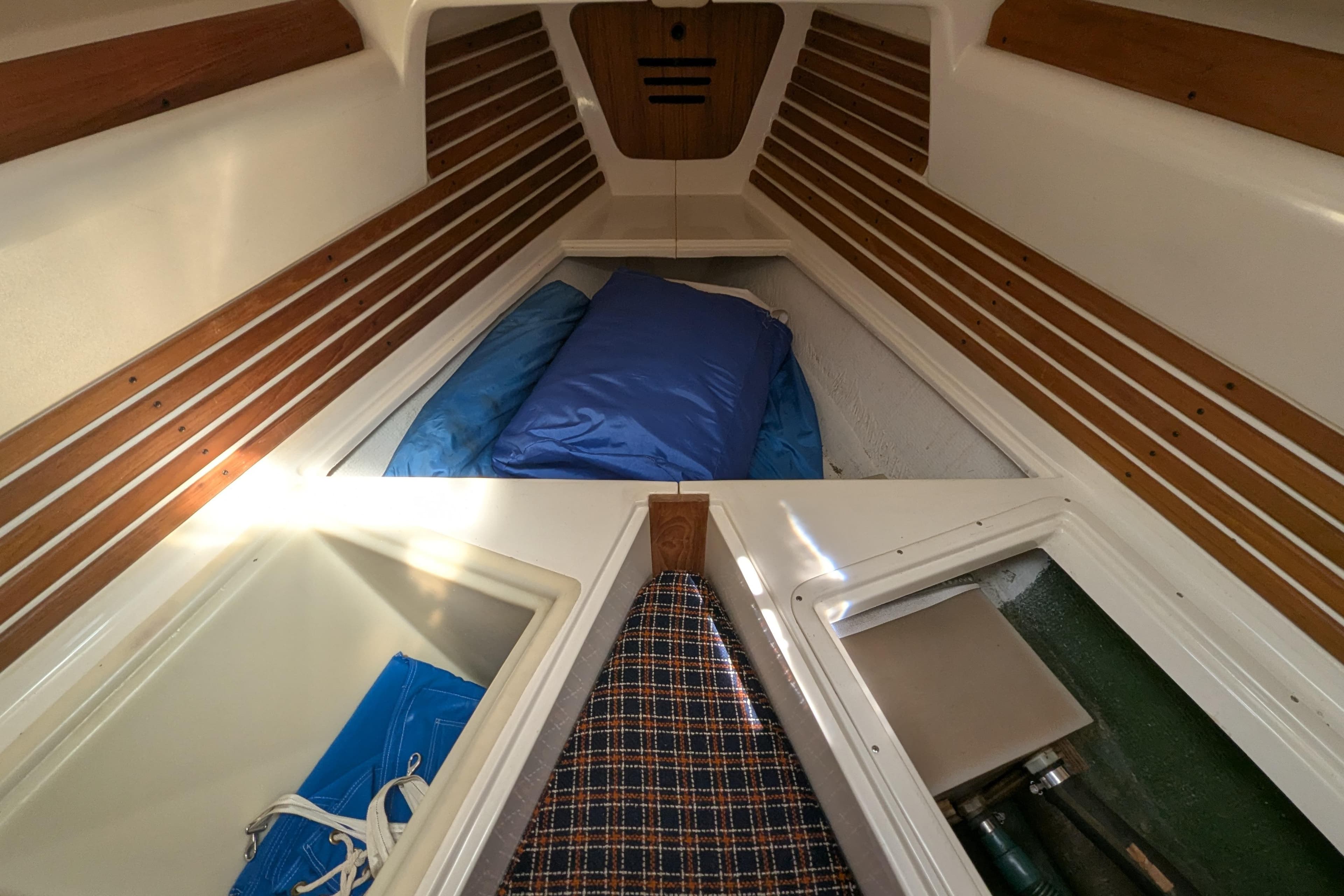 Interior cabin of a 1982 Pearson 323 sailboat with wooden accents and storage compartments.