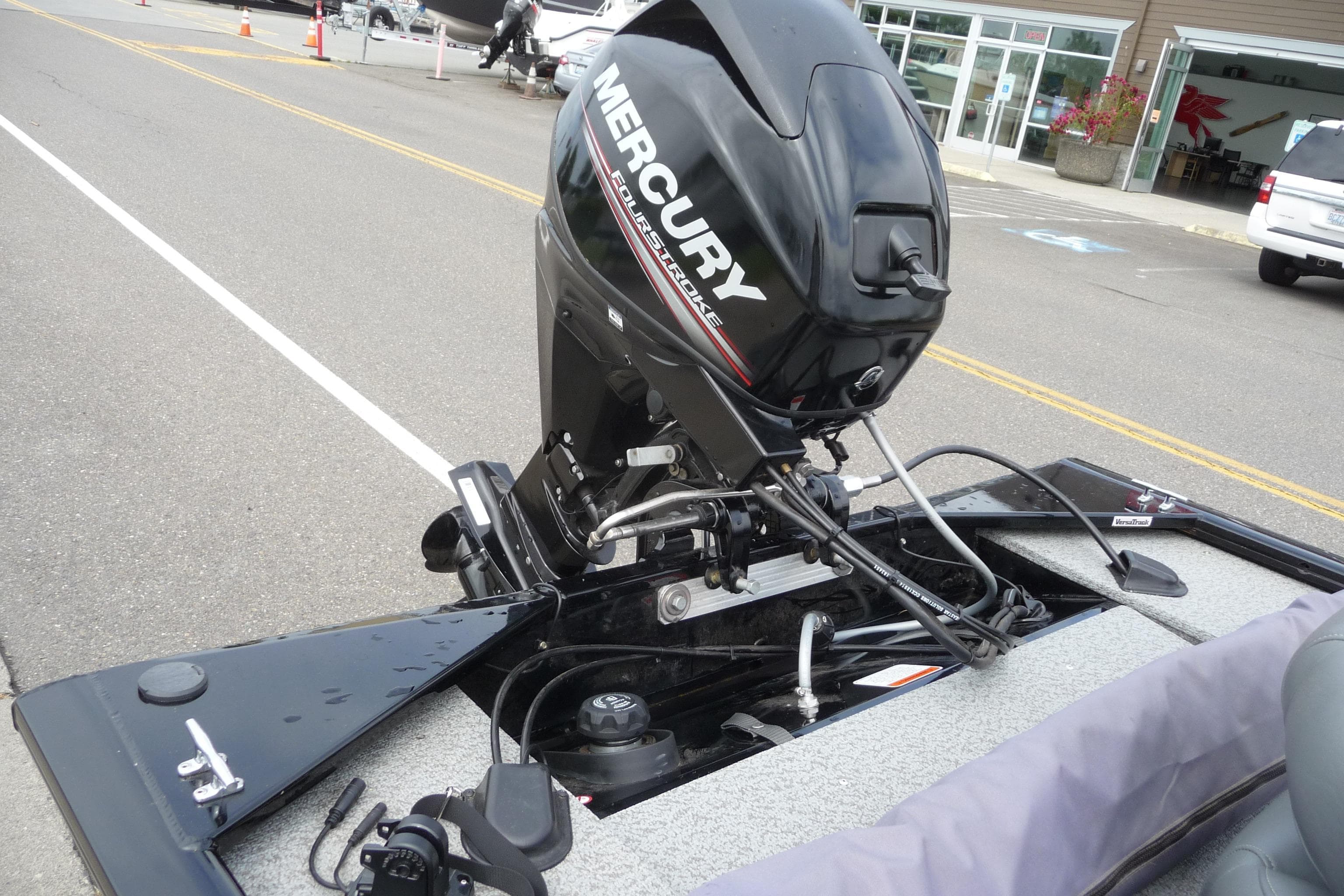 2019 Tracker Panfish 16 boat with Mercury outboard motor in a parking lot.