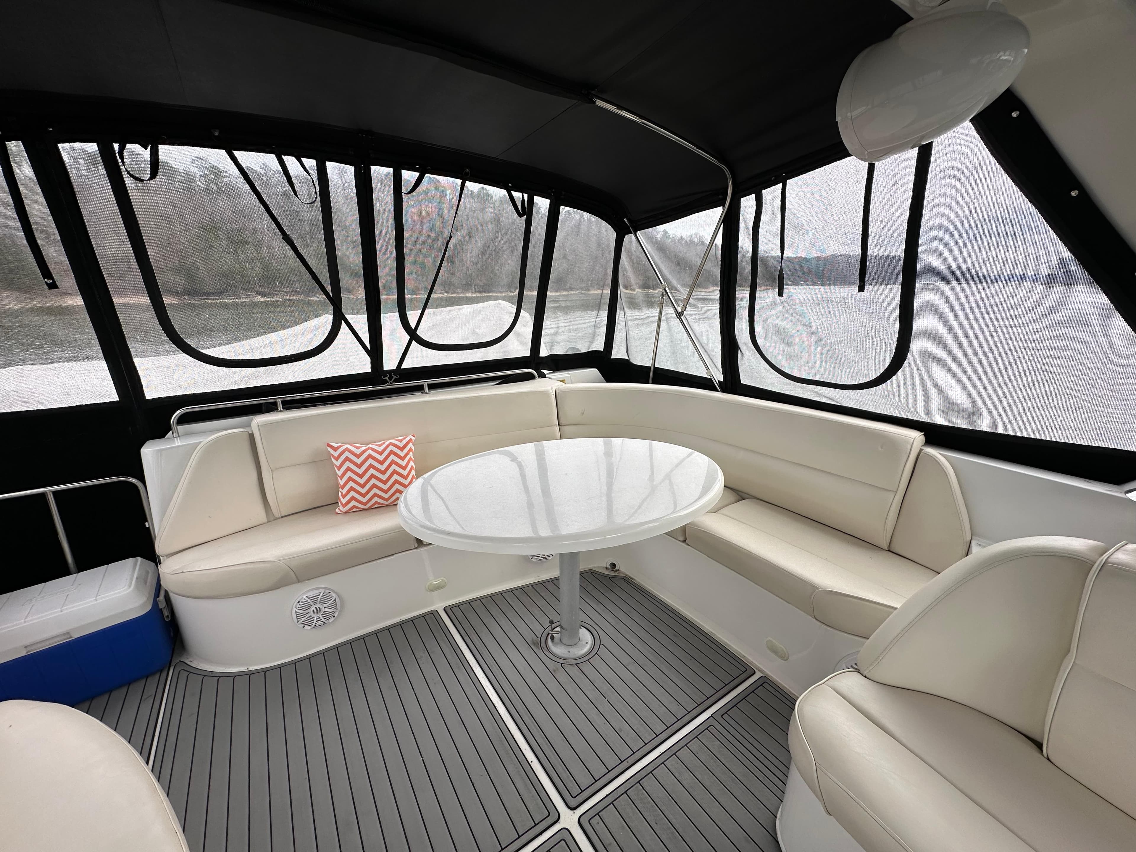 Interior seating area of 2001 Carver 570 Voyager Pilothouse yacht with round table.