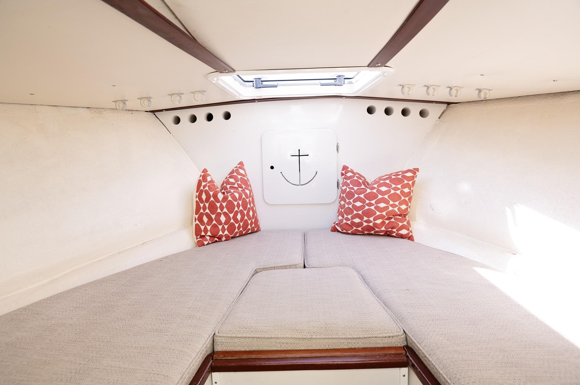 1969 Bertram 31 Classic cabin interior with cozy bedding and decorative pillows.