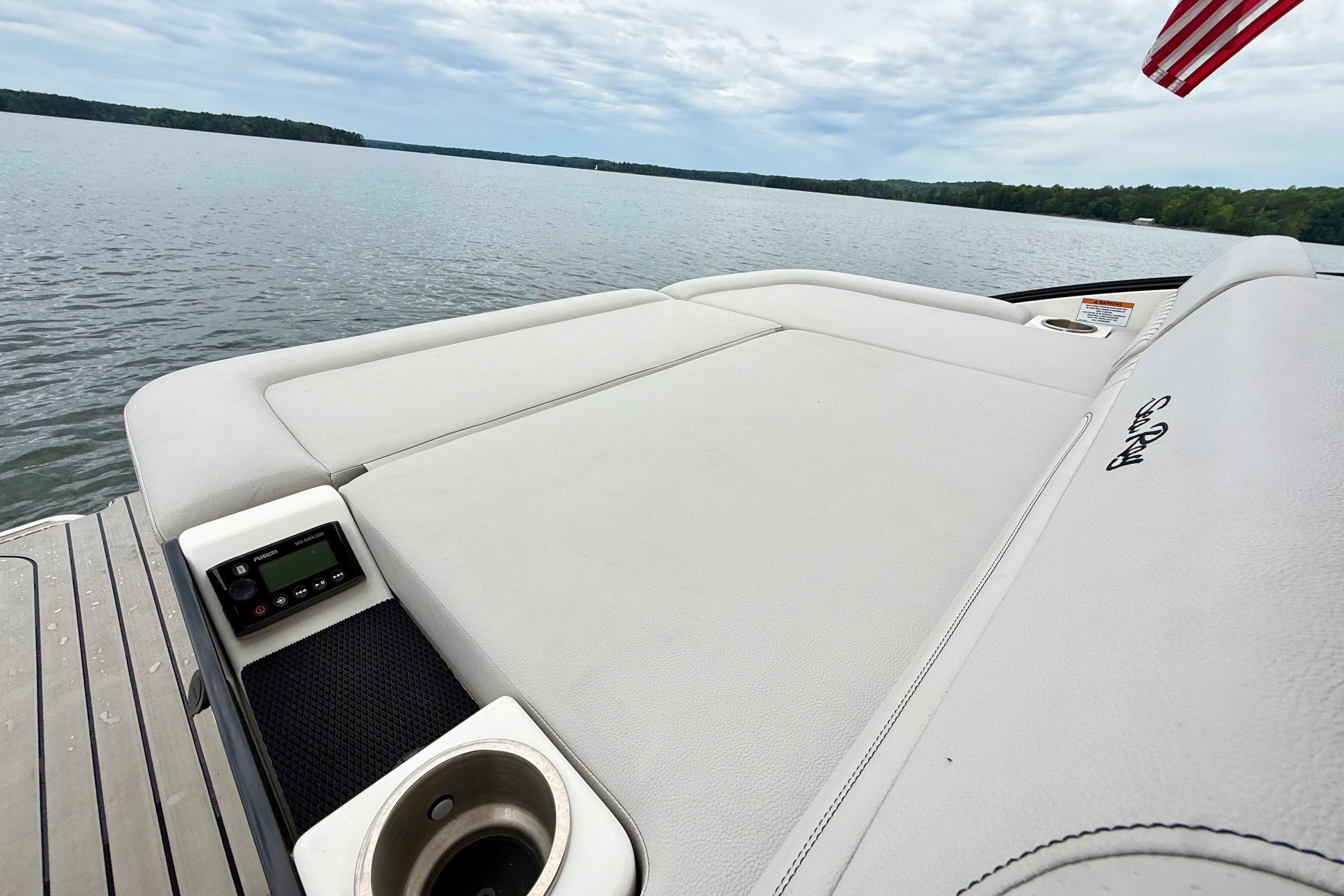 2023 Sea Ray SLX 260 boat with spacious sunpad and lake view.
