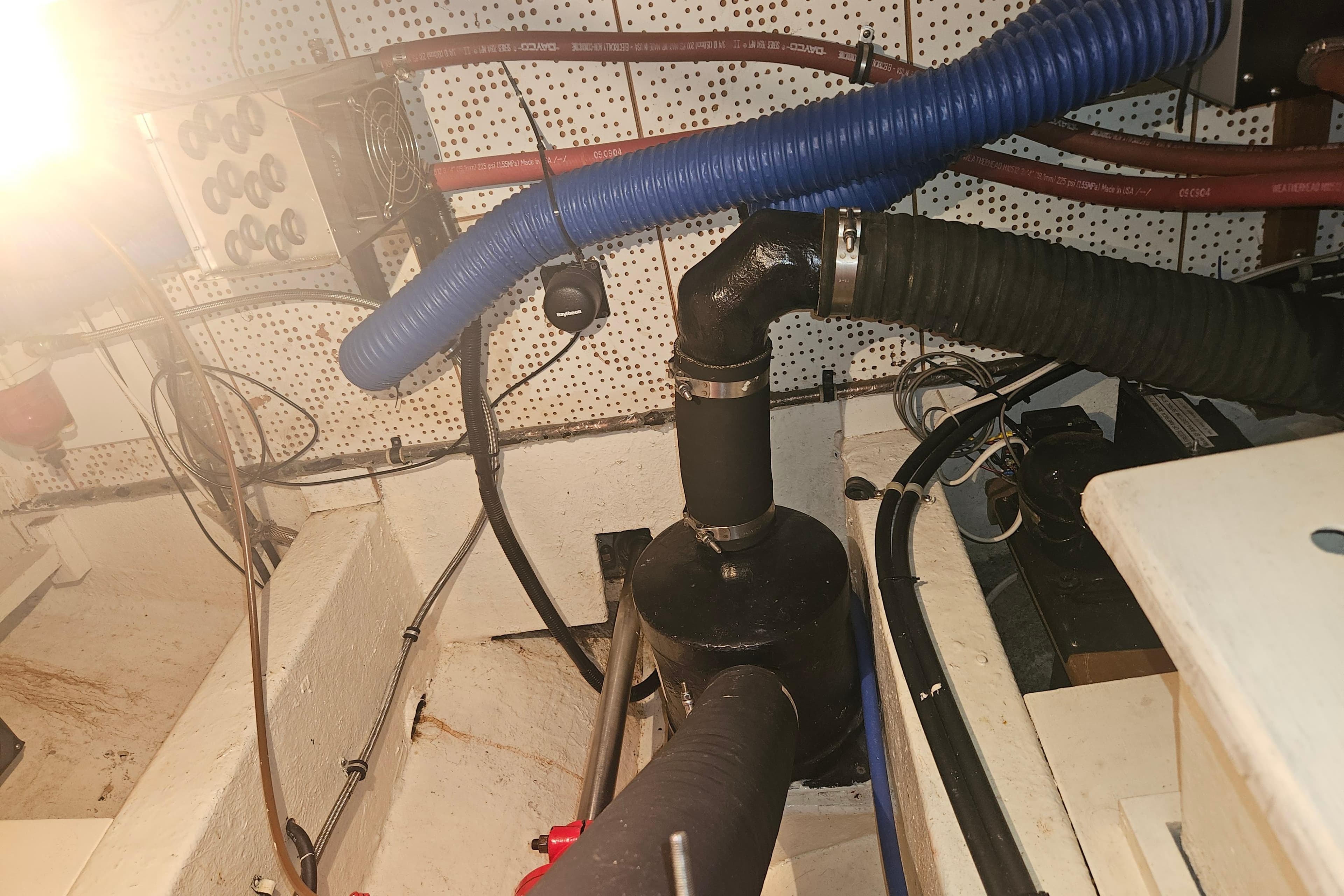 Engine room of a 1978 CHB 34 boat with visible hoses and wiring.