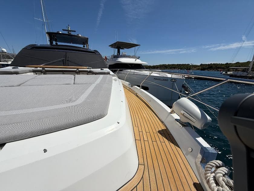 Luxury yacht Galeon 700 Sky 2021 docked, featuring sleek design and spacious deck.