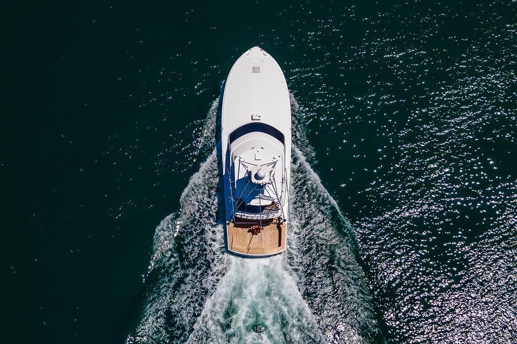 Aerial view of 2014 Hatteras 63 GT yacht cruising on open water.