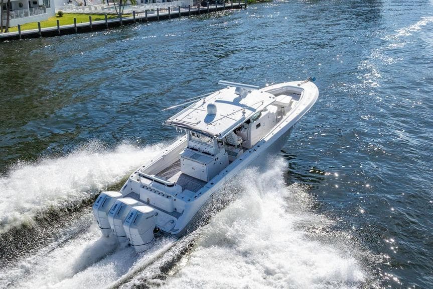 2024 HCB 42 Lujo boat cruising on a sunny waterway, showcasing powerful engines.
