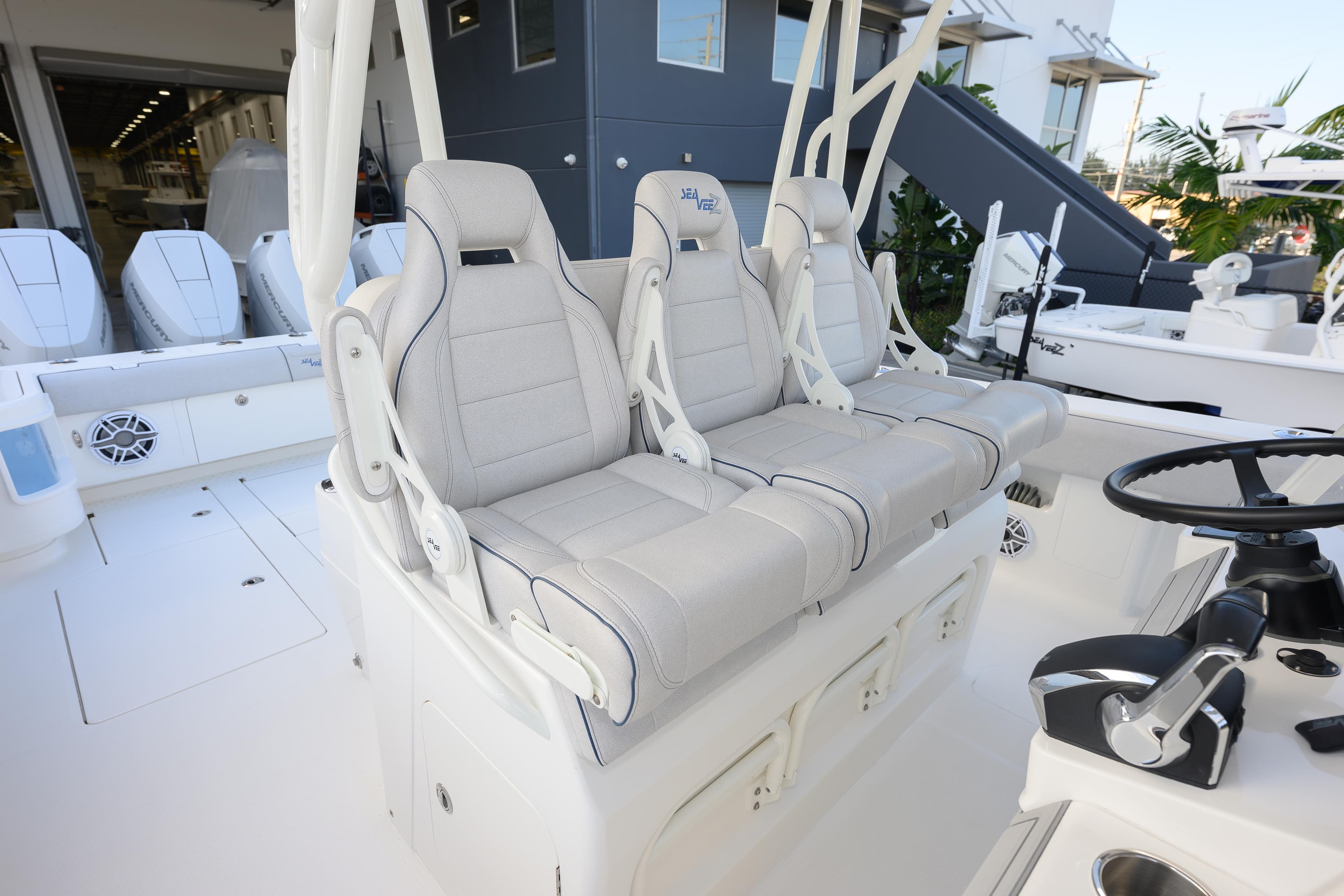 2025 SeaVee 400Z boat interior with three luxury seats and modern steering console.