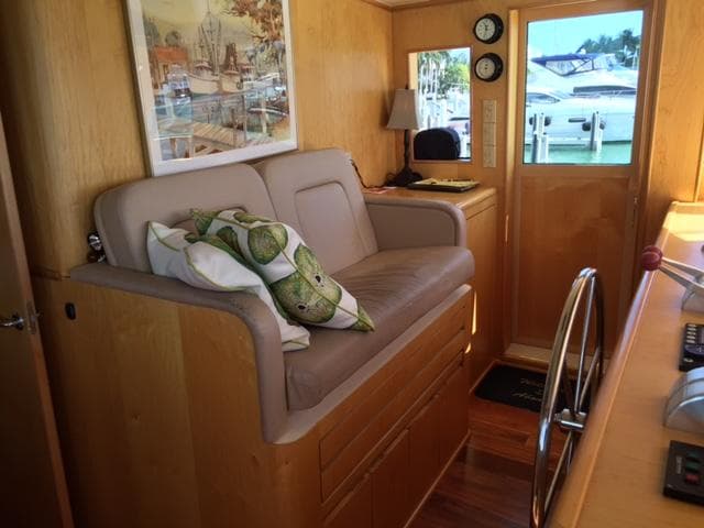 Interior of 1998 Hatteras 74 Sport Deck yacht with seating and helm station.