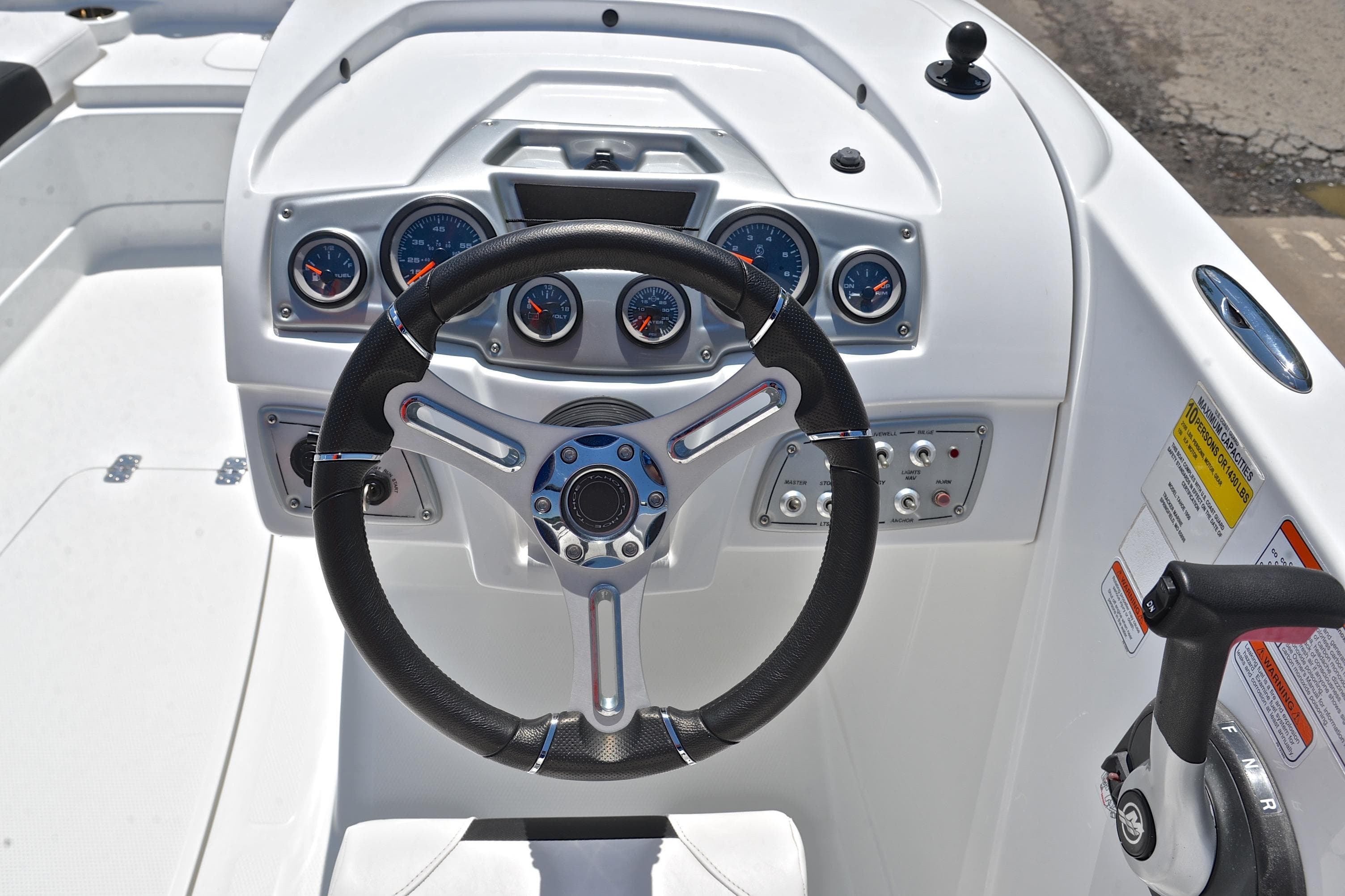 Steering console of a 2018 Tahoe 1950 boat with gauges and controls.